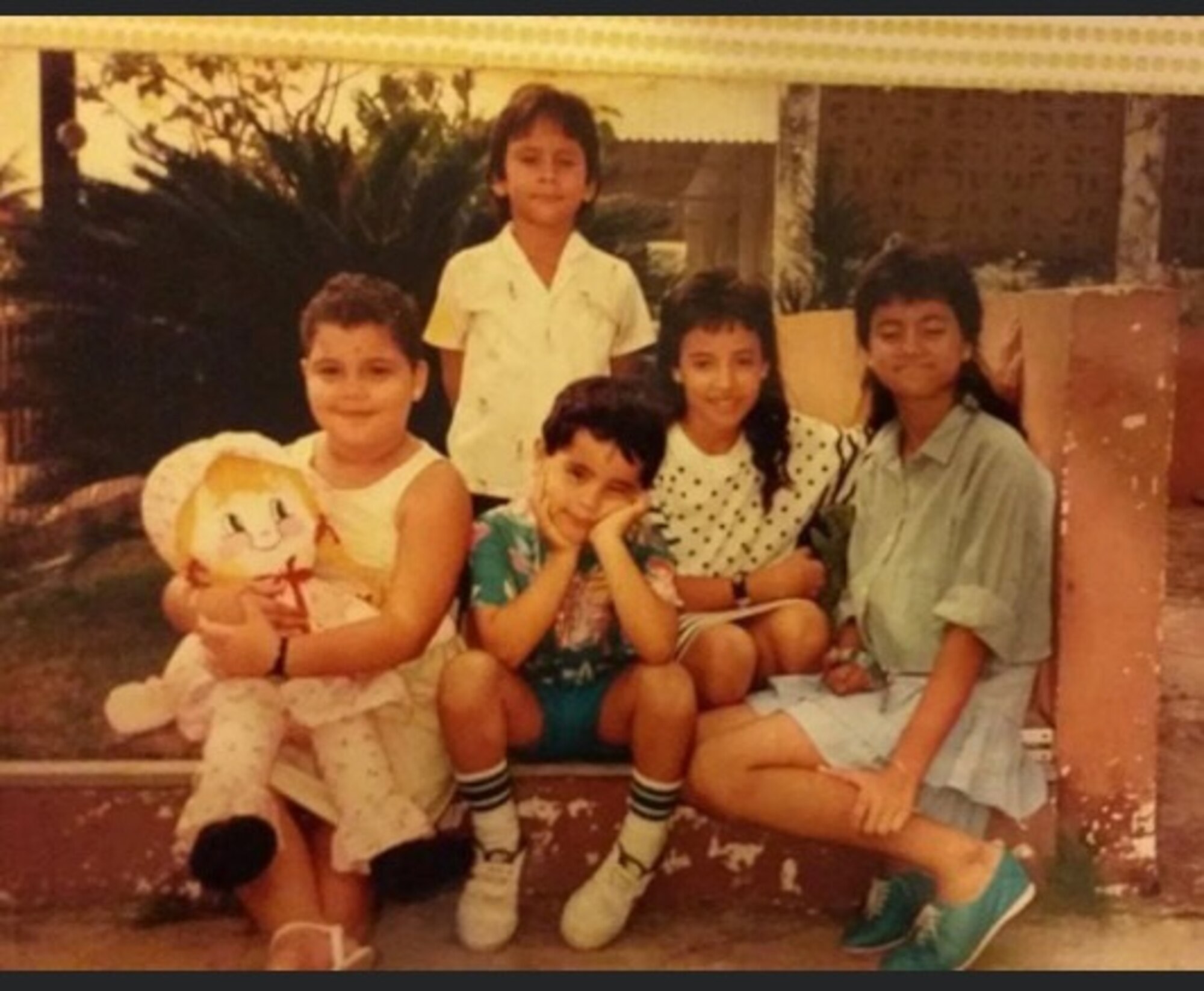 A young Master Sgt. Heriberto Mercado Rodriguez, 27th Special Operations Logistics Readiness Squadron C-130 aircraft parts storage section chief, (middle) takes a family photo with his cousins in San Juan, Puerto Rico. Though he did not have any siblings, Mercado lived in the same home as his cousins. (Courtesy Photo)