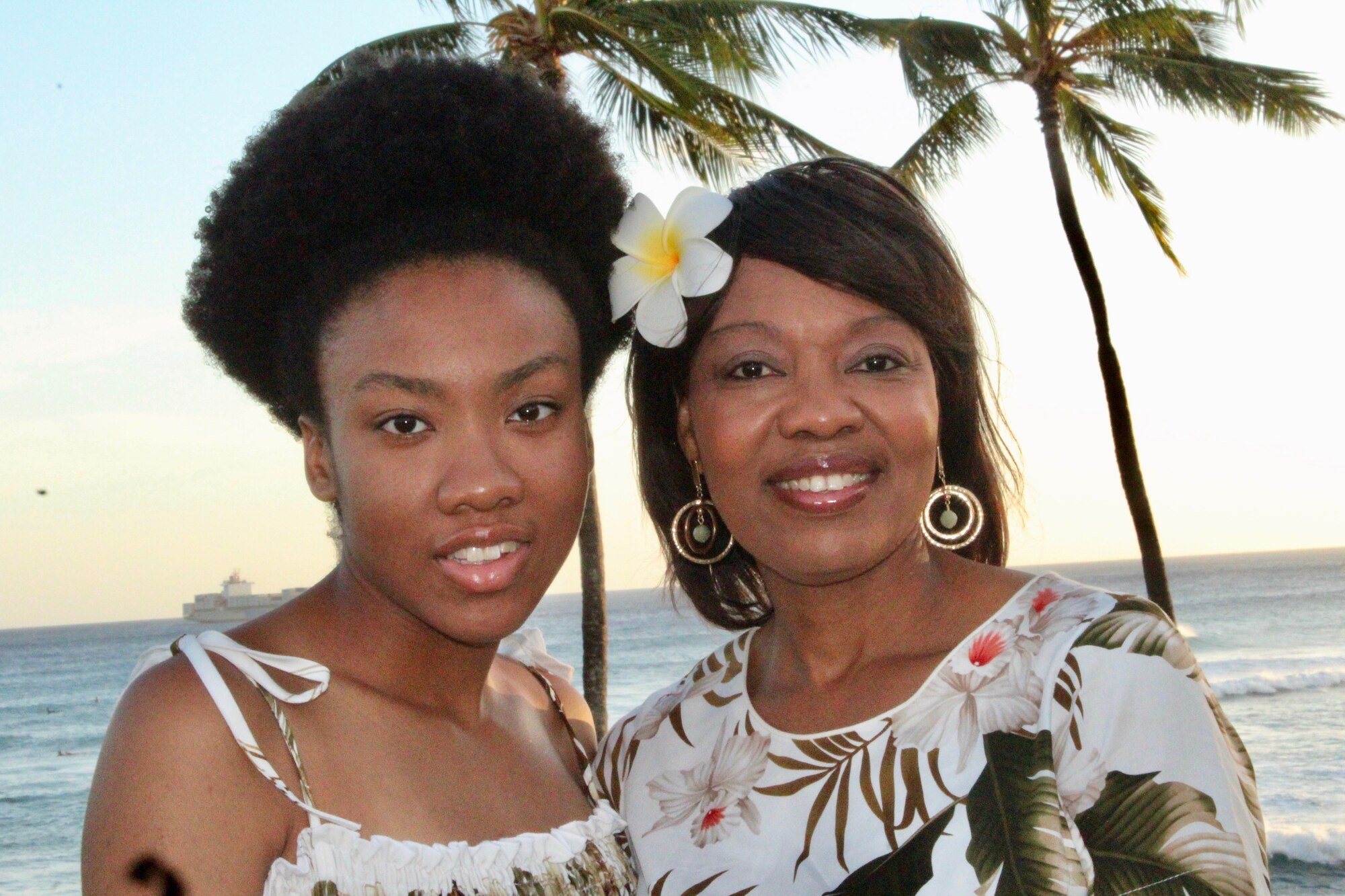 Machelle Terrell, 15th Wing suicide and violence prevention program manager, and her daughter take a family photo with the sunset behind them in Hawaii, September 1, 2020. The 15th Wing suicide prevention program has launched the "#ConnectToProtect" campaign with the goal of connecting people to prevent suicide. (Courtesy Photo)