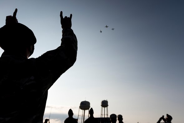 Members of team XL eagerly watch a flyover at Laughlin Air Force Base, Texas, celebrating the Air Force's 73rd Birthday on Sept. 18, 2020. This flyover was to honor and celebrate the 73 years of service it has devoted to protecting this nation. (U.S Air Force Photo by Senior Airman Anne McCready)