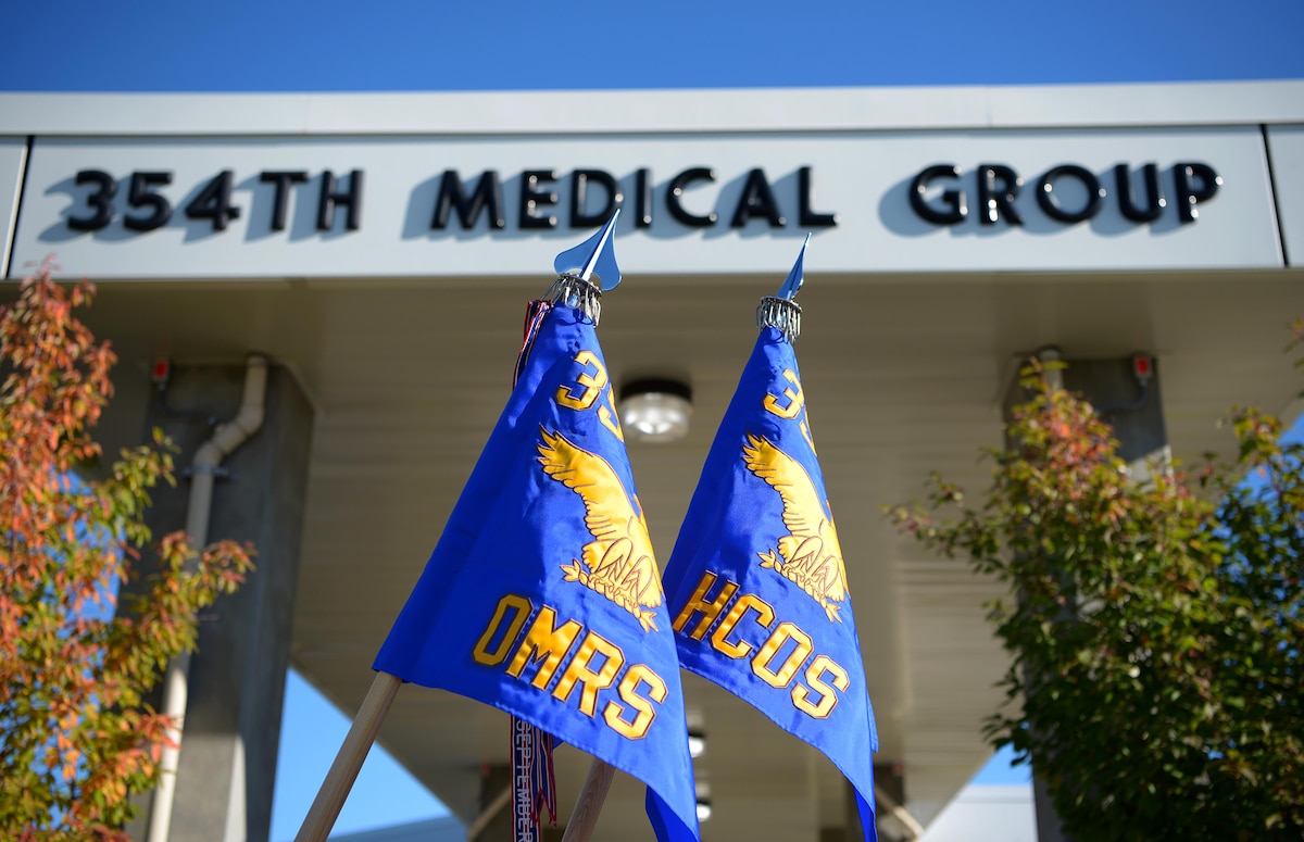 The new 354th Operational Medical Readiness Squadron and 354th Healthcare Operations Squadron guidons in front of the 354th Medical Group on Eielson Air Force Base, Alaska, Sept. 21, 2020. The 354th MDG has reorganized the way they provide healthcare to active-duty troops and families in order to boost readiness across the Air Force. (U.S. Air Force photo by Senior Airman Beaux Hebert)