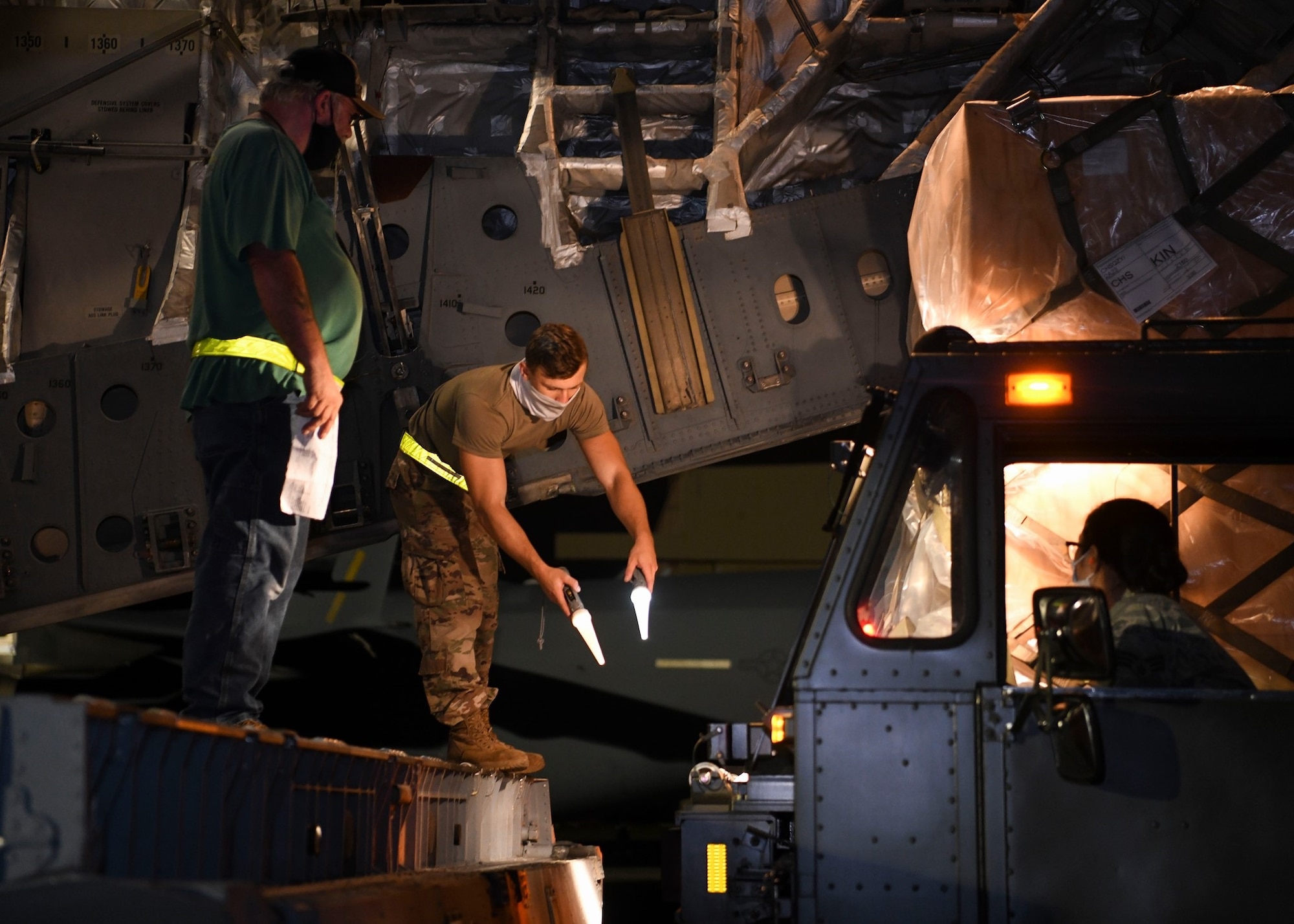 Picture of service members loading a U.S. aircraft with cargo.
