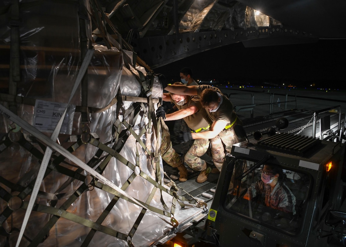 Picture of service members loading cargo onto a U.S. aircraft.