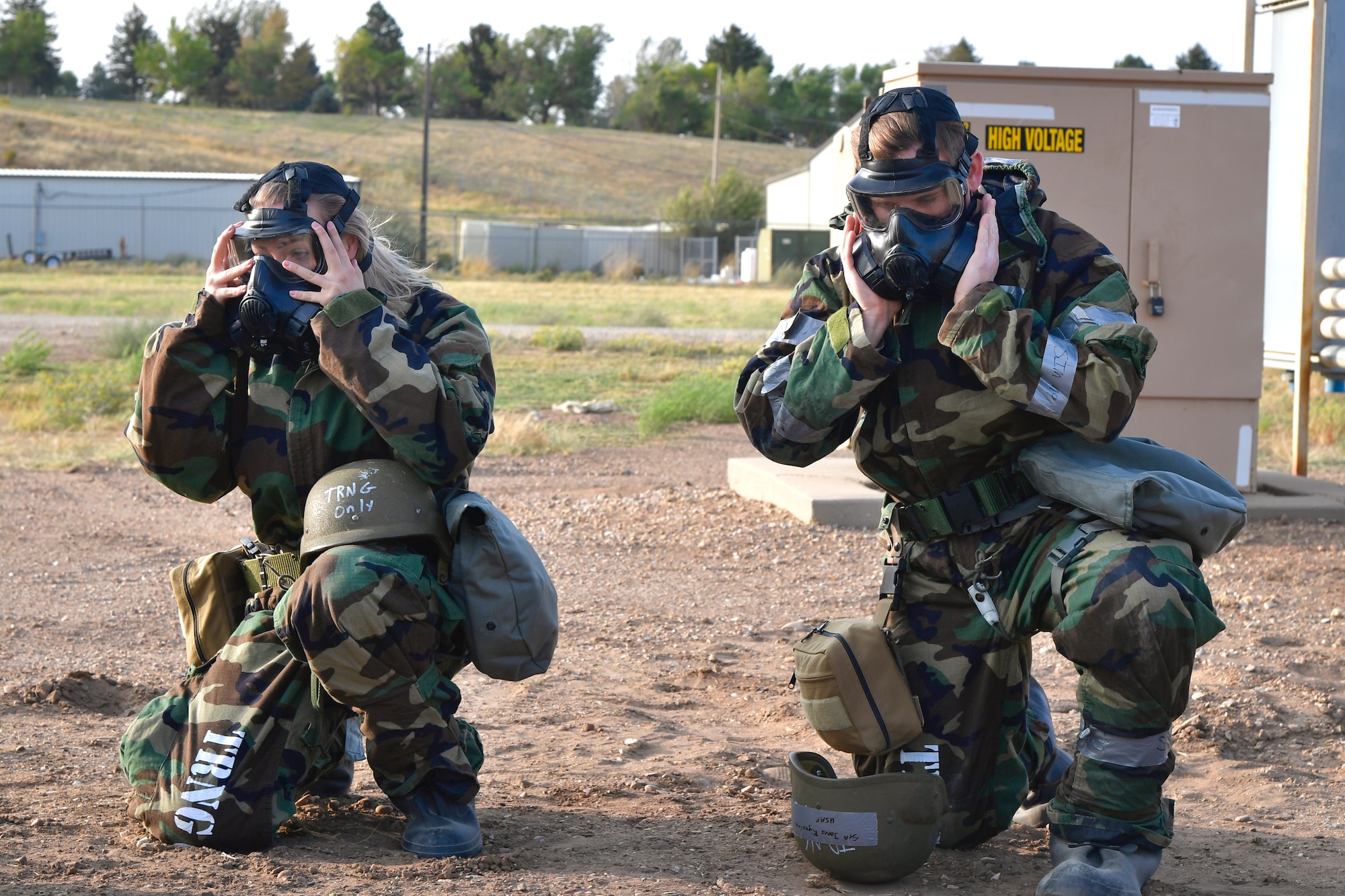 Senior Airman Ashley Epperson (left), 75th Communications and Information Directorate, and Senior Airman Colten Jones Riquelme, 75th Aerospace Medicine Squadron, don protective gear