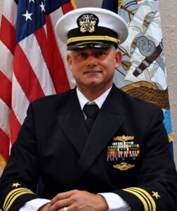 Official portrait of Lt. Cmdr. Gilbert R. Baughn, the officer-in-charge of Naval Computer & Telecommunication Area Master Station Detachment Jacksonville.