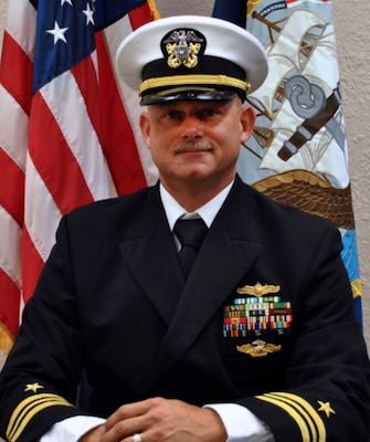 Official portrait of Lt. Cmdr. Gilbert R. Baughn, the officer-in-charge of Naval Computer & Telecommunication Area Master Station Detachment Jacksonville.