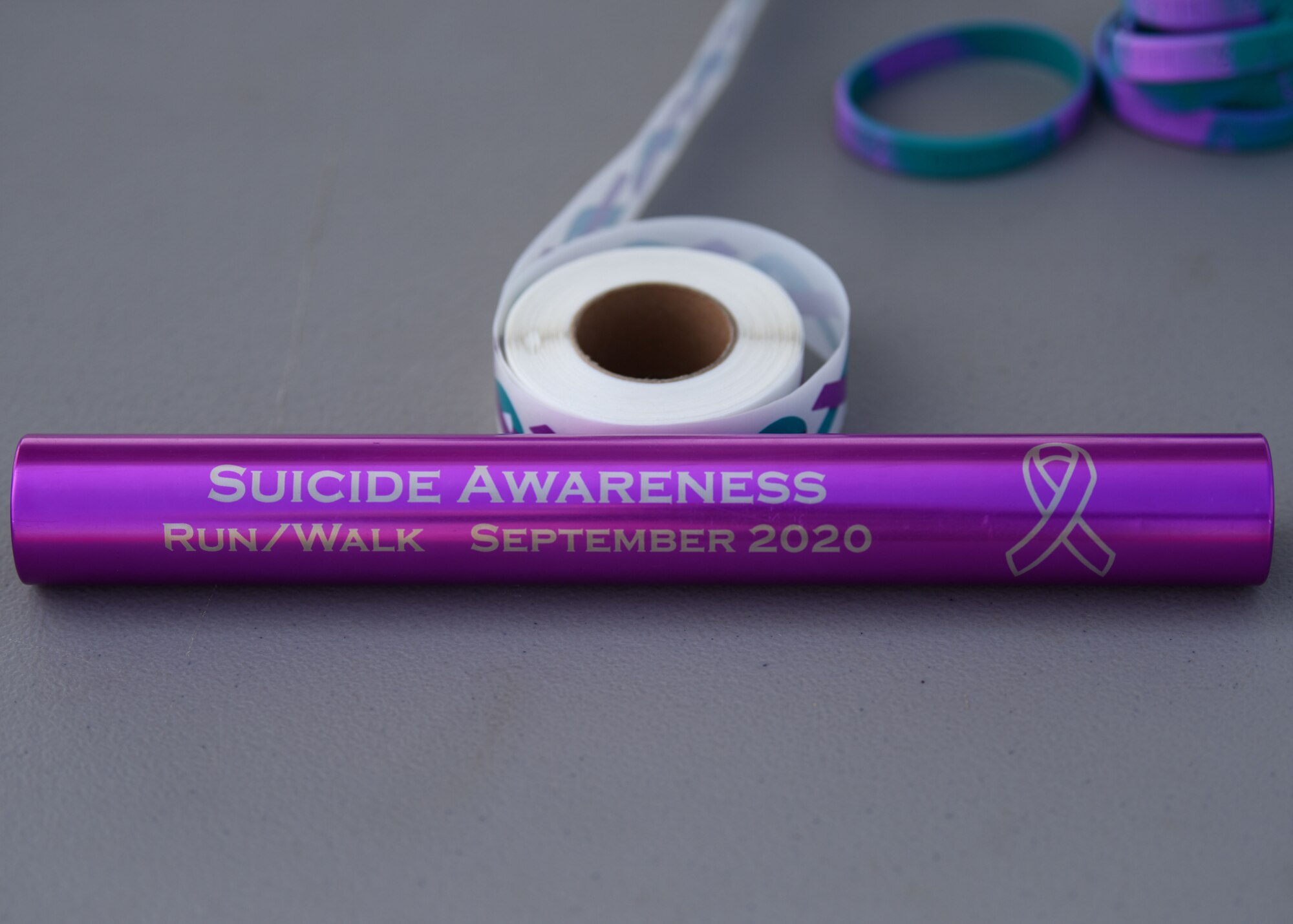 A baton is displayed on the sign-up table at the Suicide Awareness 24 Hour Run/Walkathons at the Mathis Field Track on Goodfellow Air Force Base, Texas, Sept. 18, 2020. The baton was carried by participants throughout the run/walk. (U.S. Air Force photo by Airman 1st Class Ethan Sherwood)