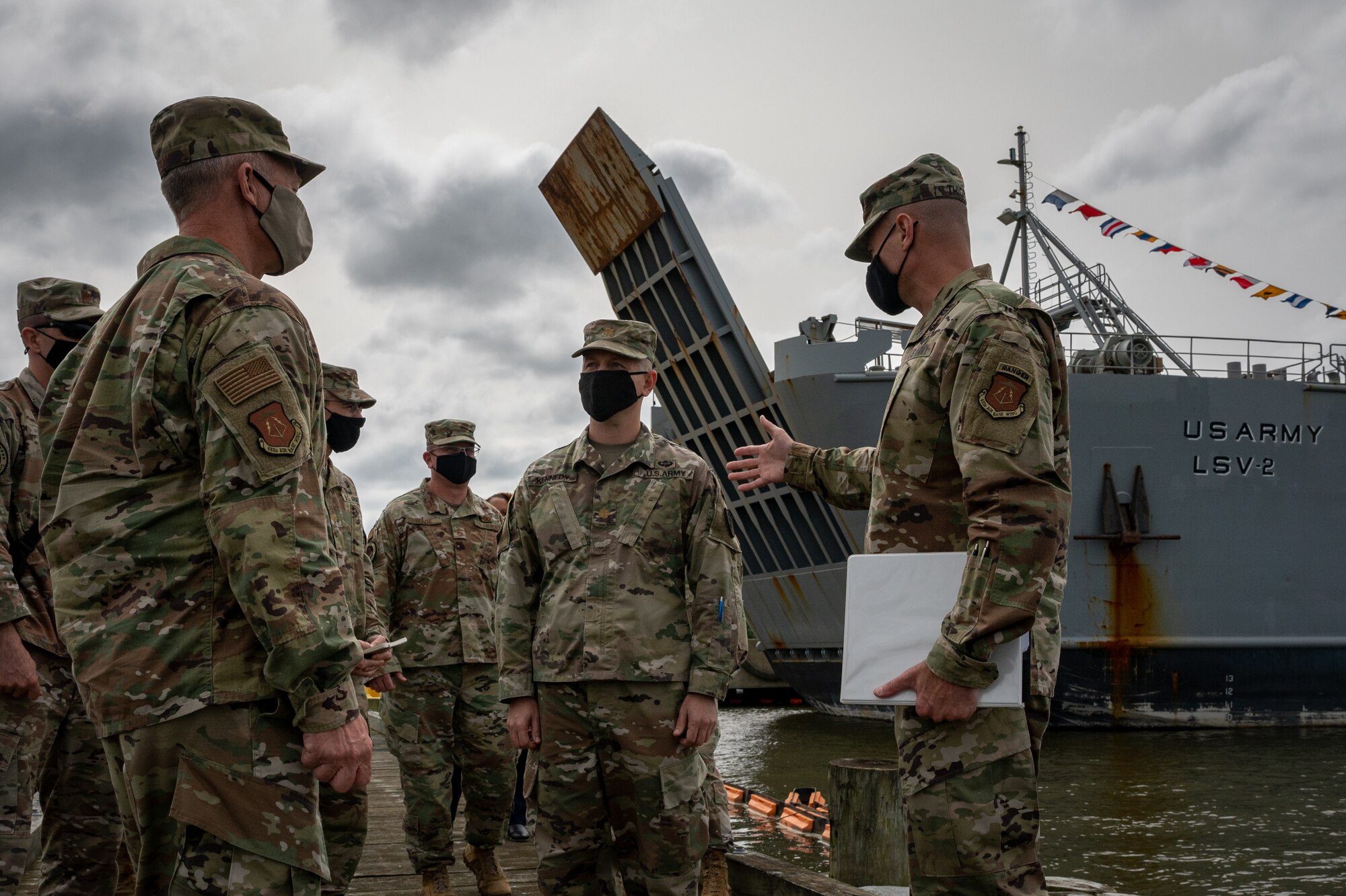 U.S. Air Force Gen. Mark Kelly, Commander of Air Combat Command coins a Soldier.
