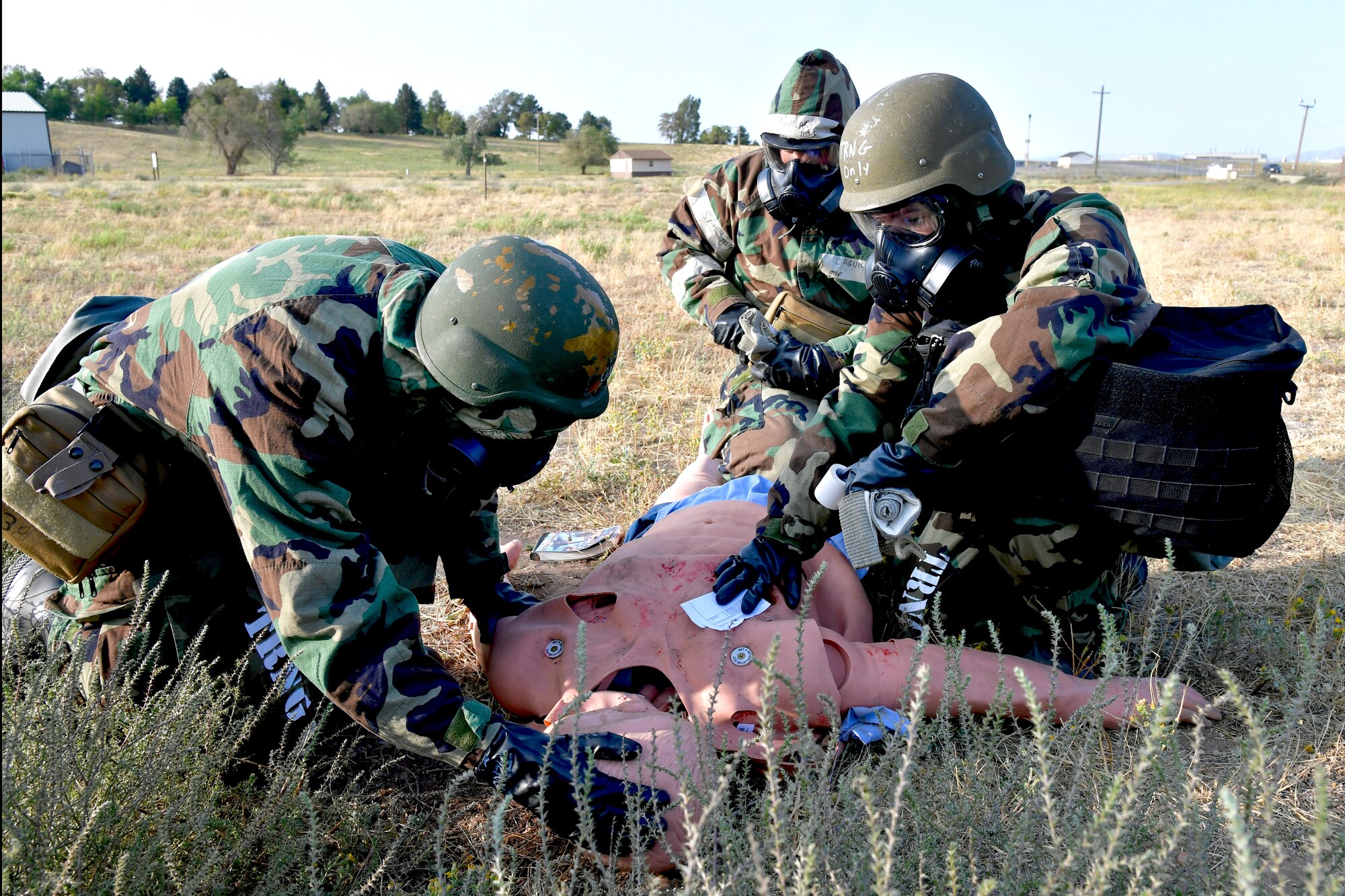 (Left to right) Chaplain (Capt.) Jeffrey Larsen, 75th Air Base Wing chapel, Master Sgt. Christopher Aguilar, 75th Air Base Wing safety office, and Senior Airman Ashley Epperson, 75th Communications and Information Directorate, practice emergency first-aid on a mannequin during a readiness training exercise.