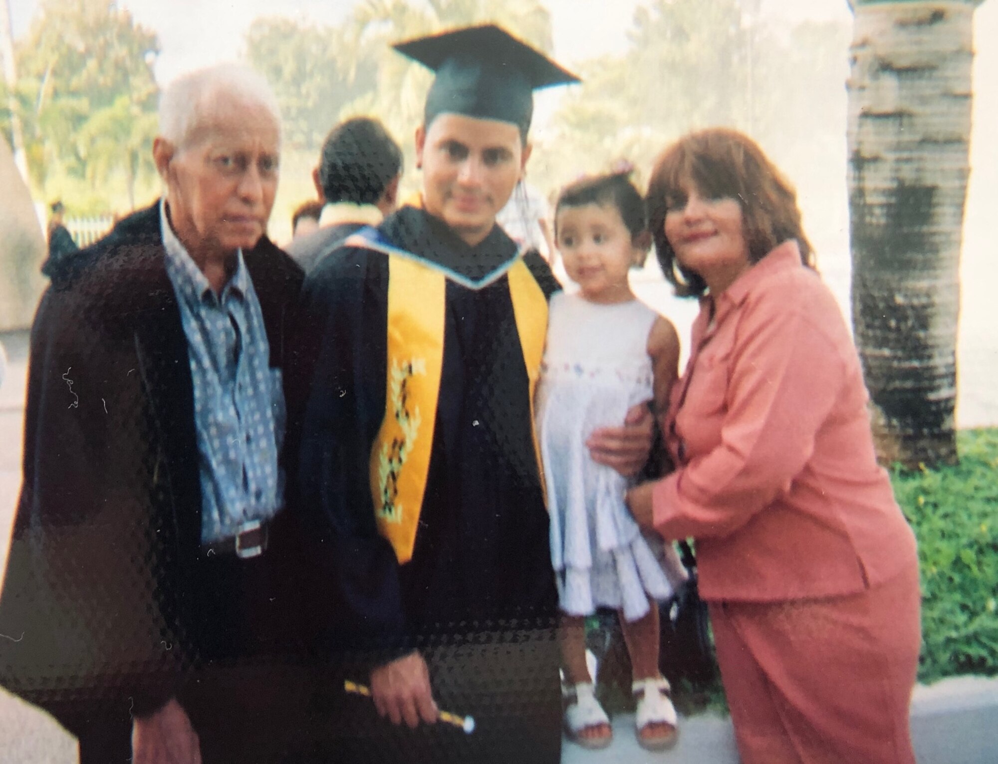 A young Master Sgt. Heriberto Mercado Rodriguez, 27th Special Operations Logistics Readiness Squadron C-130 aircraft parts storage section chief, takes a photo with his family after graduating from the University of Puerto Rico at San Juan, Puerto Rico. Mercado graduated college while running a business and starting a family. (Courtesy Photo)