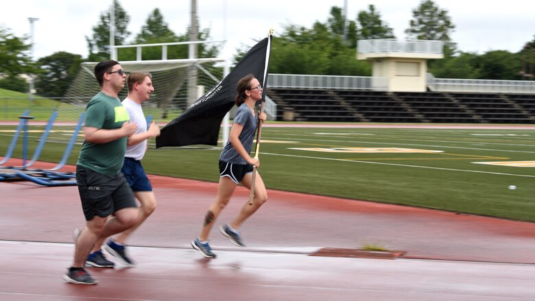 Members of Team Misawa participate in a 24-hour ruck to pay homage to those missing and to those who gave the ultimate sacrifice during the National Prisoner of War/Missing in Action Recognition Day at Misawa Air Base, Japan, Sept. 18, 2020. People from across the base participated in 30-minute shifts to keep the POW/MIA flag moving, non-stop for the entire 24-hour event. (U.S. Air Force photo by Staff Sgt. Grace Nichols)