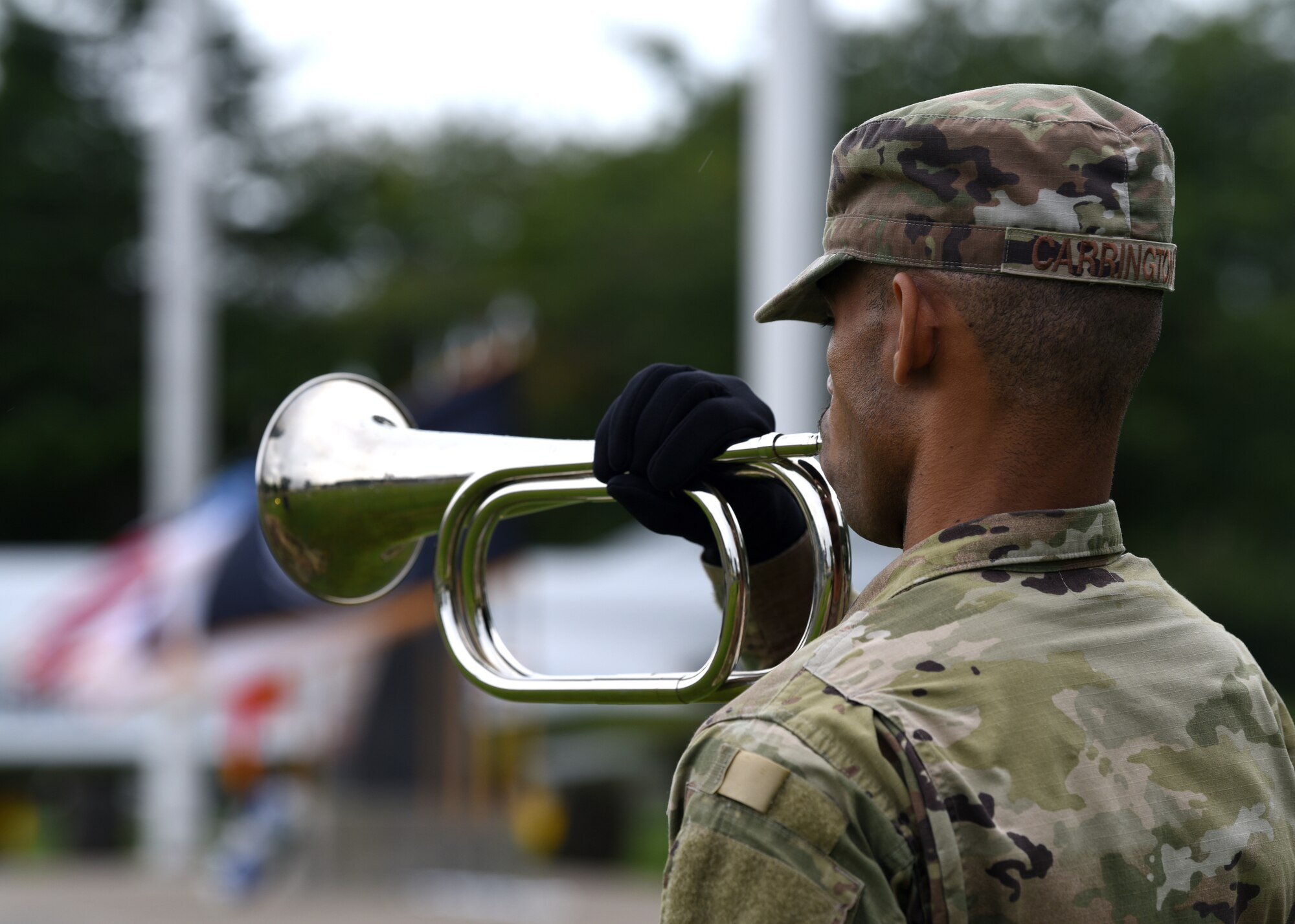 U.S. Air Force Staff Sgt. Murtadiy Carrington, 35th Force Support Squadron Honor Guard bugle player, performs Taps during the POW/MIA Ceremony at Misawa Air Base, Japan, Sept. 18, 2020.  Since World War I, approximately 83,400 U.S. service members are still unaccounted for, and more than 150,000 Americans have been held as prisoners of war. (U.S. Air Force photo by Staff Sgt. Grace Nichols)
