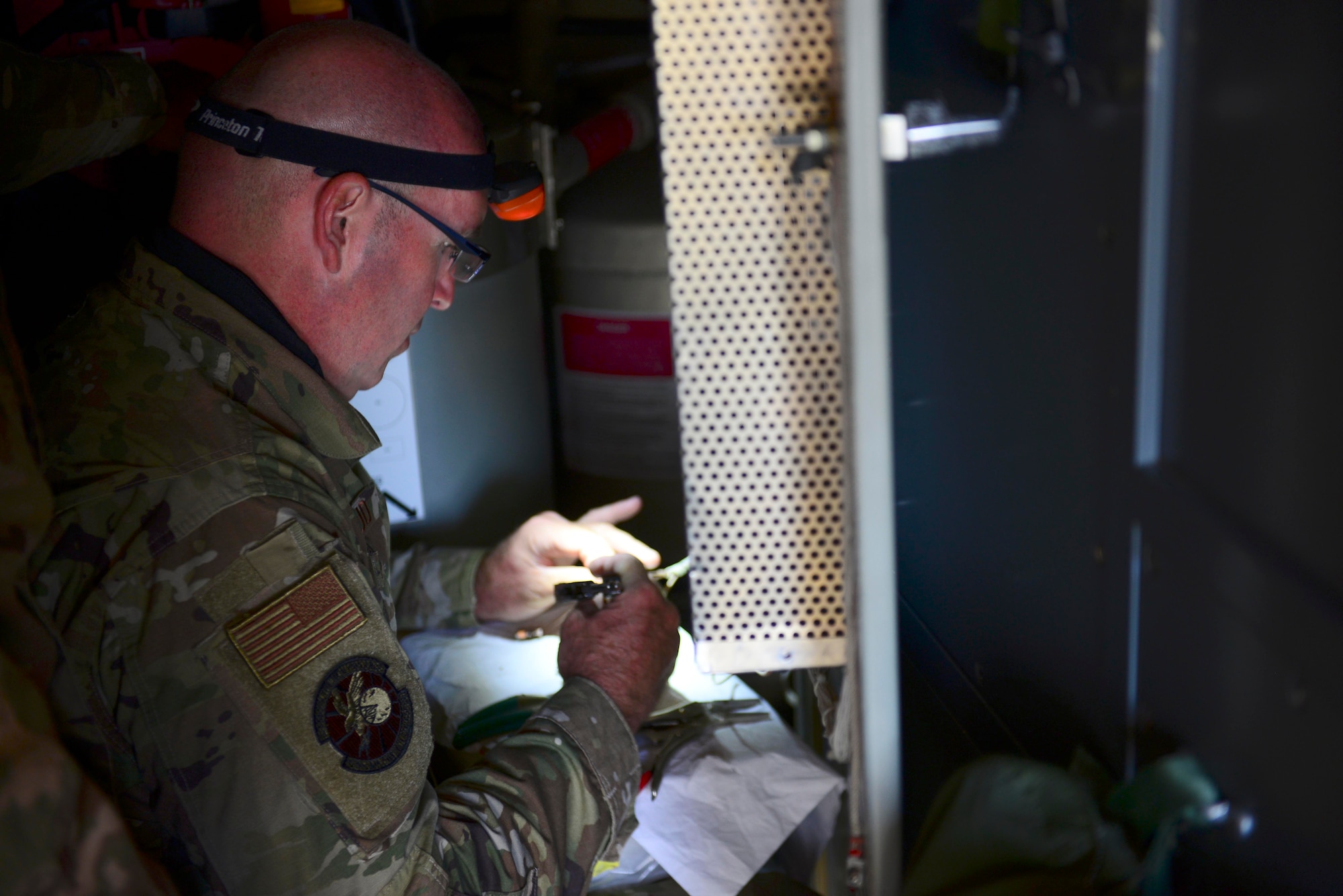 U.S. Air Force Master Sgt. Jay Mastrud, 128th Air Control Squadron noncommissioned officer in charge of radar, attempts to repair a cable during exercise Astral Knight 20 at Malbork Air Base, Poland, Sept. 21, 2020. The 128th ACS, an Air National Guard unit, integrated with the 606th Air Control Squadron assigned to Aviano Air Base during Astral Knight 20. (U.S. Air Force photo by Tech. Sgt. Tory Cusimano)