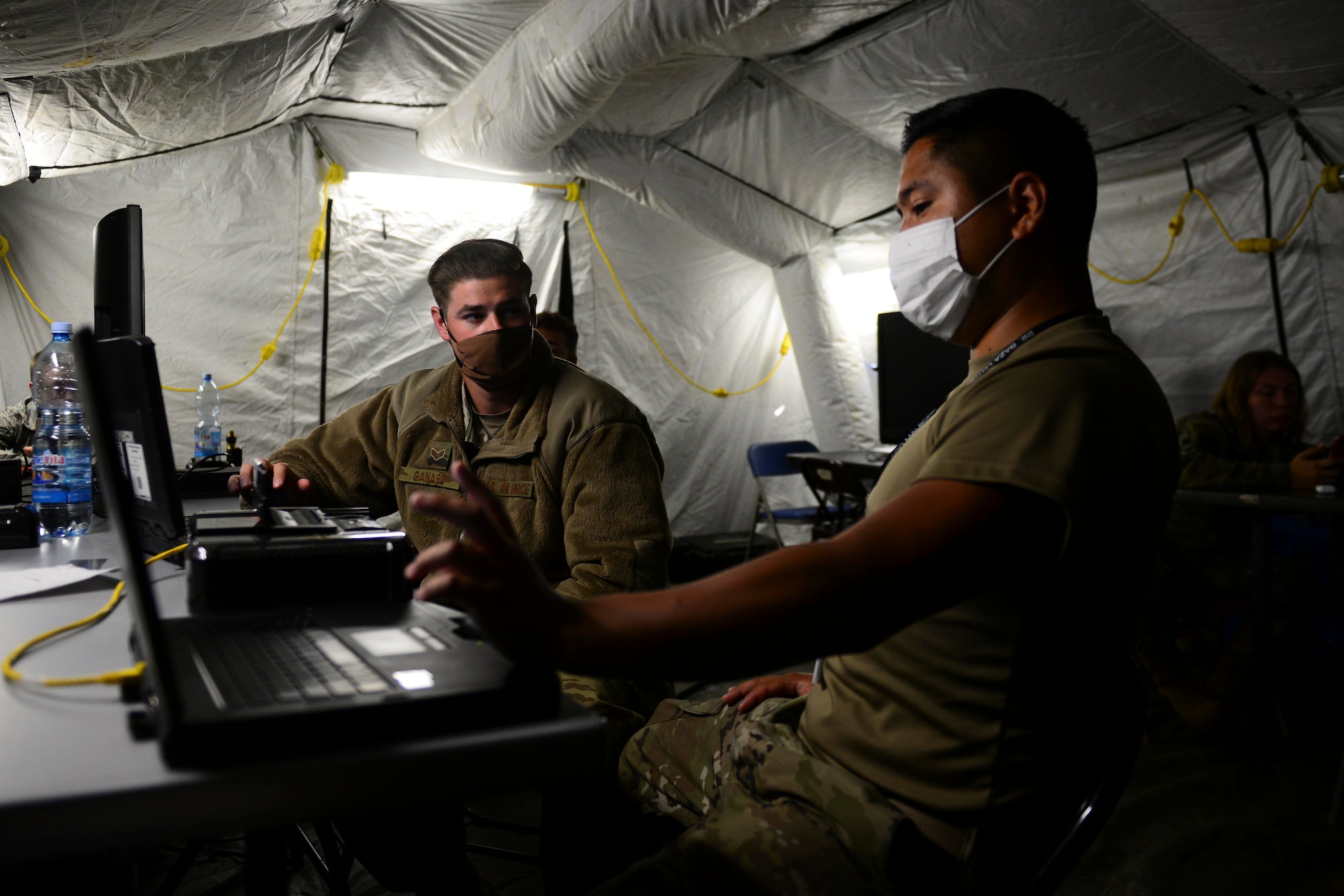 Senior Airman Joshua Olortegui, 606th Air Control Squadron theater deployable communications technician, right, configures an executive communications kit during exercise Astral Knight 20 at Malbork Air Base, Poland, Sept. 21, 2020. The ECK provides connectivity to a variety of mission-critical communication platforms. (U.S. Air Force photo by Tech. Sgt. Tory Cusimano)