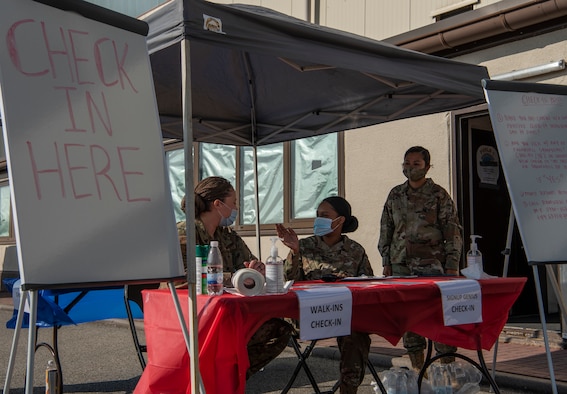 U.S. Air Force Airmen volunteers speak to each other at a table during the 73rd Air Force Birthday Celebration at Ramstein Air Base, Germany, Sept. 18, 2020.