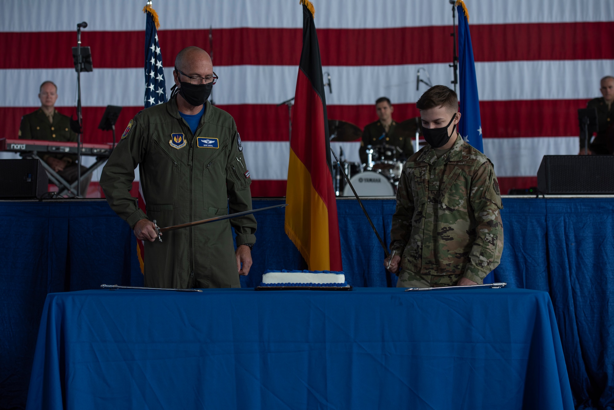 U.S. Air Force Col. David Duval, United States Air Forces in Europe Aerospace and Operational Medicine chief, and Airman 1st Class Cameron Donk, 24th Intelligence Squadron geospatial analyst, prepare to cut the cake during the 73rd Air Force Birthday Celebration at Ramstein Air Base, Germany, Sept. 18, 2020.