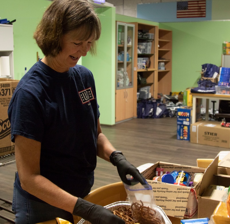 Jean Wash, a USO volunteer and Army spouse fills bags with snacks for Soldiers at the Deployment Processing Center, Rhine Ordnance Barracks in Kaiserslautern, Germany September 15, 2020. The DPC currently houses incoming personnel from the United States undergoing quarantine and in-processing to the European theater. The USO’s mission is to strengthen America's military service members by keeping them connected to family, home and country, throughout their service to the nation. (U.S. Army Reserve photo by Staff Sgt. Chris Jackson/Released)