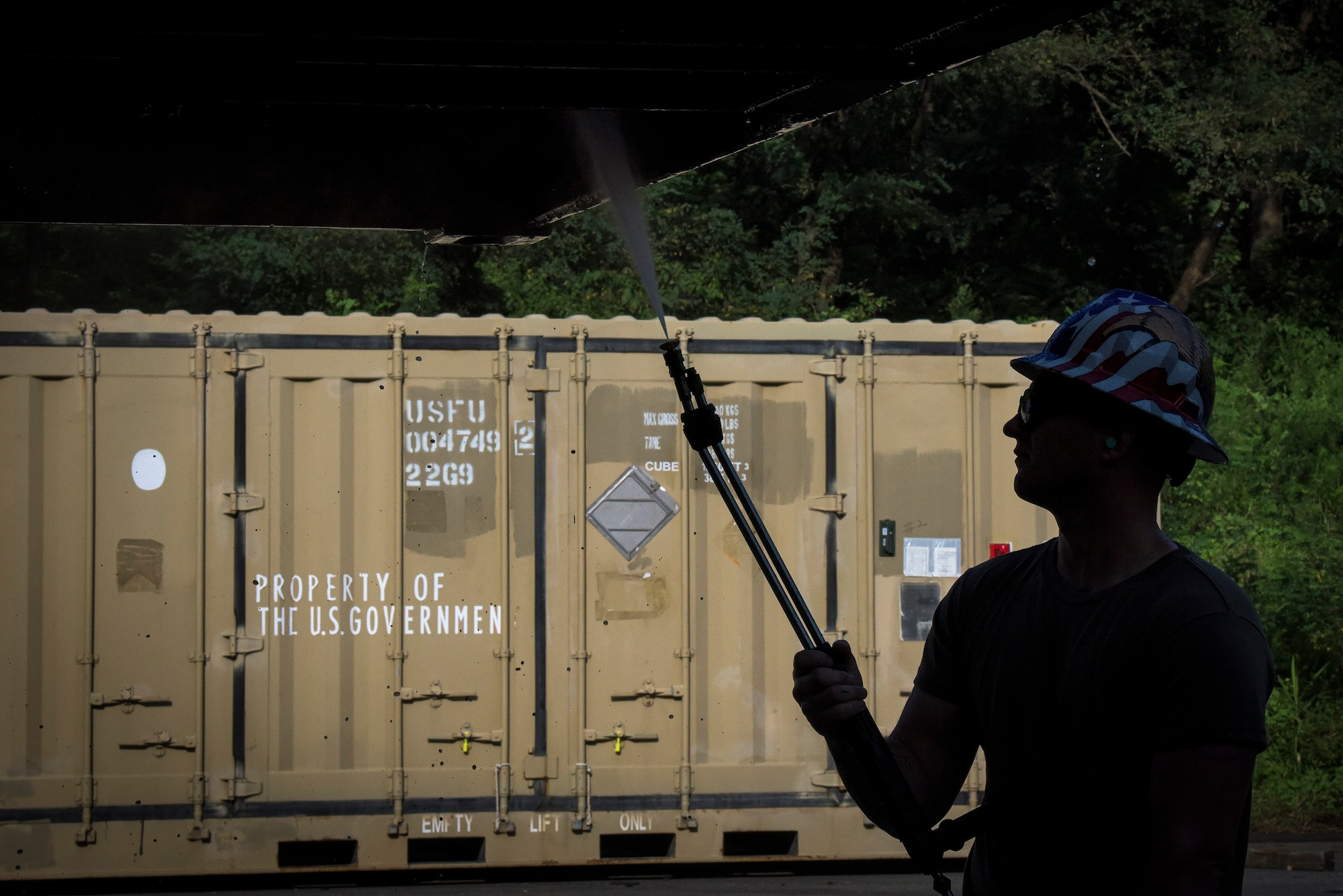 Staff Sgt. Michael Coyne, 51st Munitions Squadron shipping/receiving element crew chief, removes debris from cargo prior to a retrograde ISO operation “ammo transfer,” Aug. 25, 2020, in Pyeongtaek-si, Republic of Korea. The 51st MUNS and 51st Logistics Readiness Squadron transported excess serviceable assets valued at $13 million to Jinhae Port, Jinhae-gu, Republic of Korea, for international maritime shipping. (U.S. Air Force photo by Staff Sgt. Greg Nash)