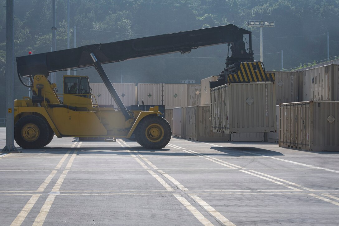 A 607th Material Maintenance Squadron transportation specialist lifts a shipping container containing Osan Air Base’s 51st Munition Squadron assets after a retrograde in support of operation “ammo transfer,” Aug. 25, 2020, at Jinhae Port, Jinhae-gu, Republic of Korea. The 51st MUNS and 51st Logistics Readiness Squadron transported excess serviceable assets, valued at $13 million, to Jinhae Port, Jinhae-gu, Republic of Korea, for international maritime shipping. (U.S. Air Force photo by Staff Sgt. Greg Nash)
