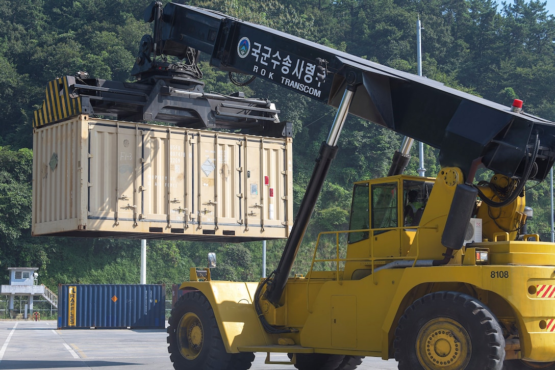A 607th Material Maintenance Squadron transportation specialist lifts a shipping container containing Osan Air Base’s 51st Munition Squadron assets after a retrograde in support of operation “ammo transfer,” Aug. 25, 2020, at Jinhae Port, Jinhae-gu, Republic of Korea. The 51st MUNS and 51st Logistics Readiness Squadron transported excess serviceable assets, valued at $13 million, to Jinhae Port, Jinhae-gu, Republic of Korea, for international maritime shipping. (U.S. Air Force photo by Staff Sgt. Greg Nash)