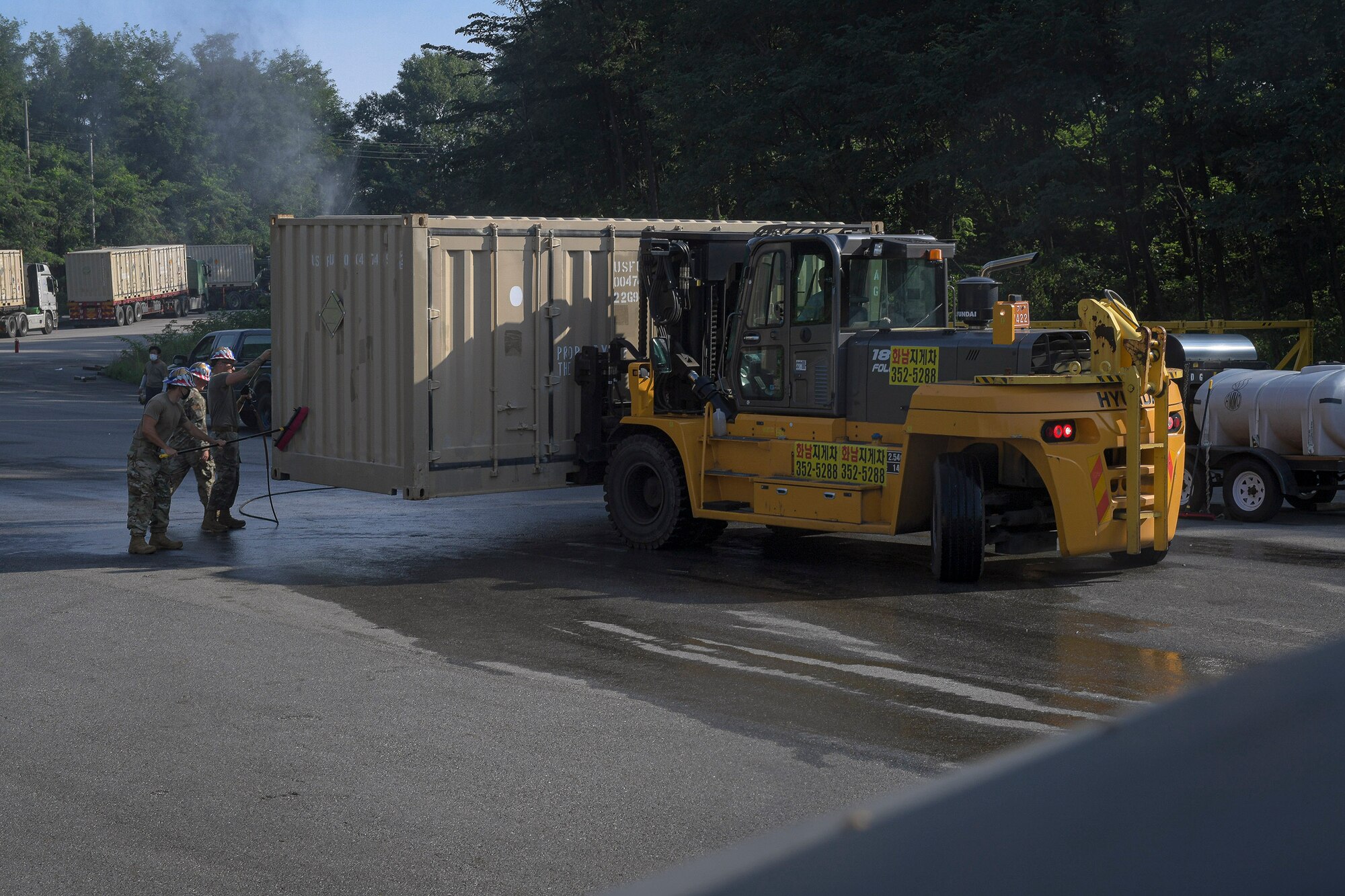 Airmen from the 51st Munitions Squadron shipping/receiving element remove debris from cargo prior to a retrograde in support of operation “ammo transfer,” Aug. 25, 2020, in Pyeongtaek-si, Republic of Korea. The 51st MUNS and 51st Logistics Readiness Squadron transported excess serviceable assets valued at $13 million to Jinhae Port, Jinhae-gu, Republic of Korea, for international maritime shipping. (U.S. Air Force photo by Staff Sgt. Greg Nash)