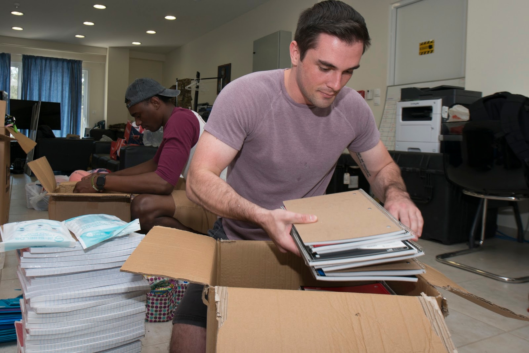 An Airman packs school supplies