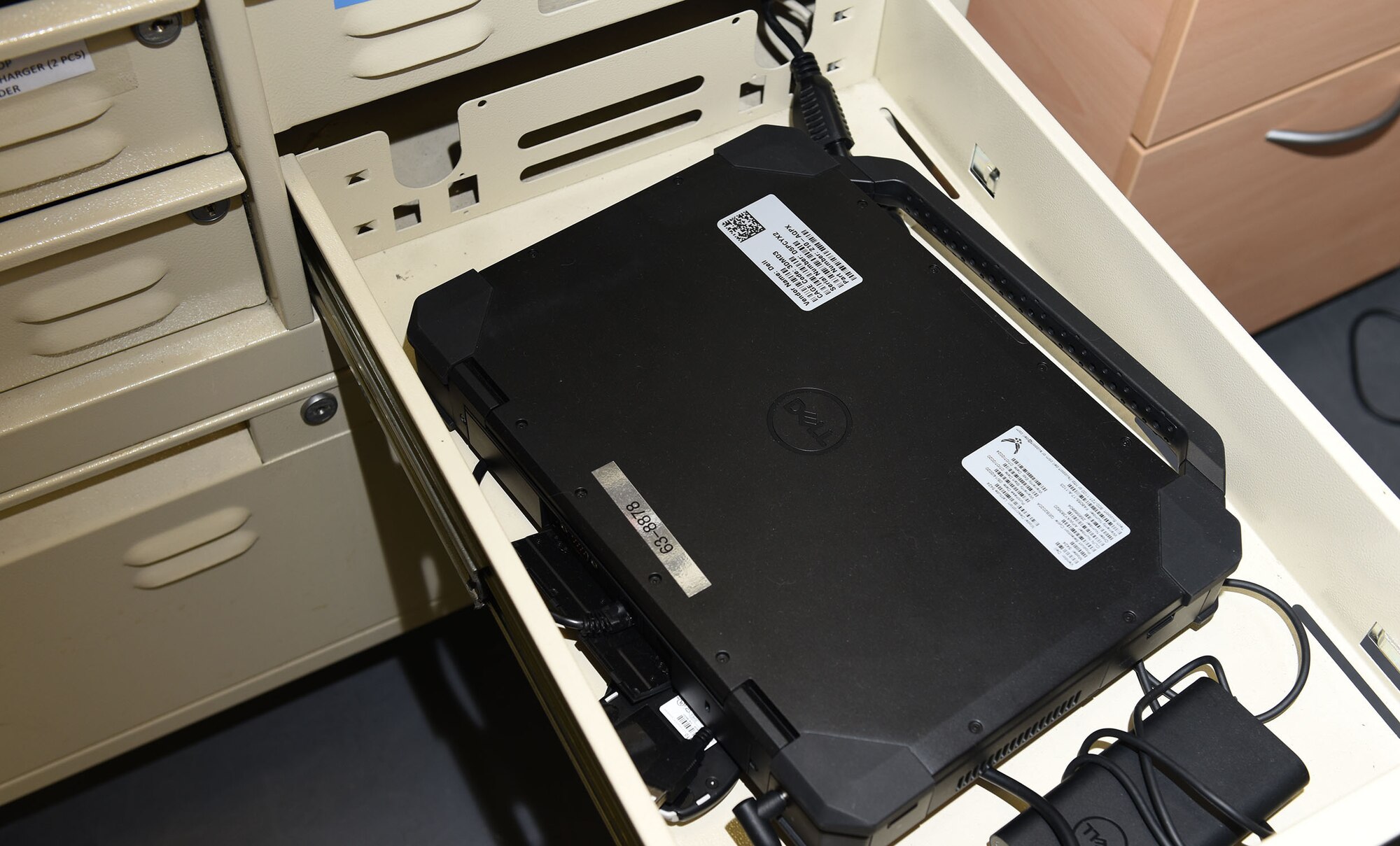 A laptop and charger, used for the 100th Maintenance Group’s virtual forms program, is stored in a cabinet at Royal Air Force Mildenhall, England, Sept. 3, 2020. Each drawer contains the equipment assigned for a specific aircraft, including WiFi pucks, which enables aircrew and flying crew chiefs to update documentation on the 100th Air Refueling Wing’s KC-135 Stratotanker aircraft anywhere in Europe without the need for paper forms. (U.S. Air Force photo by Karen Abeyasekere)