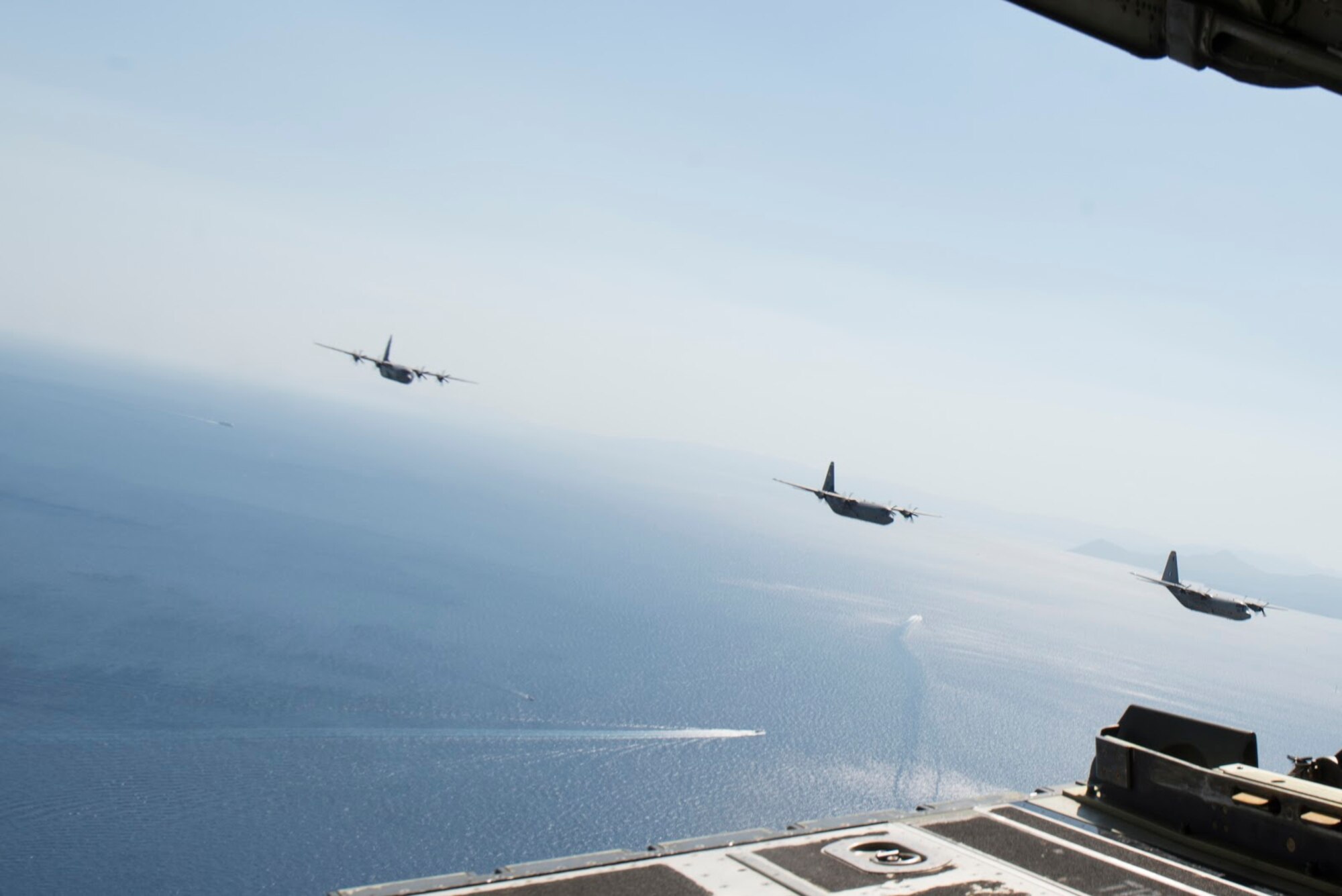 C-130J Super Hercules aircraft, one from the Hellenic armed forces and two assigned to the 86th Airlift Wing, fly over Megara Bay, Greece, during Operation Stolen Cerberus VII, Sept. 11, 2020. The exercise is designed to enhance readiness and demonstrate a shared commitment to a peaceful, stable and secure Europe. (U.S. Air Force photo by Airman 1st Class Taylor D. Slater)