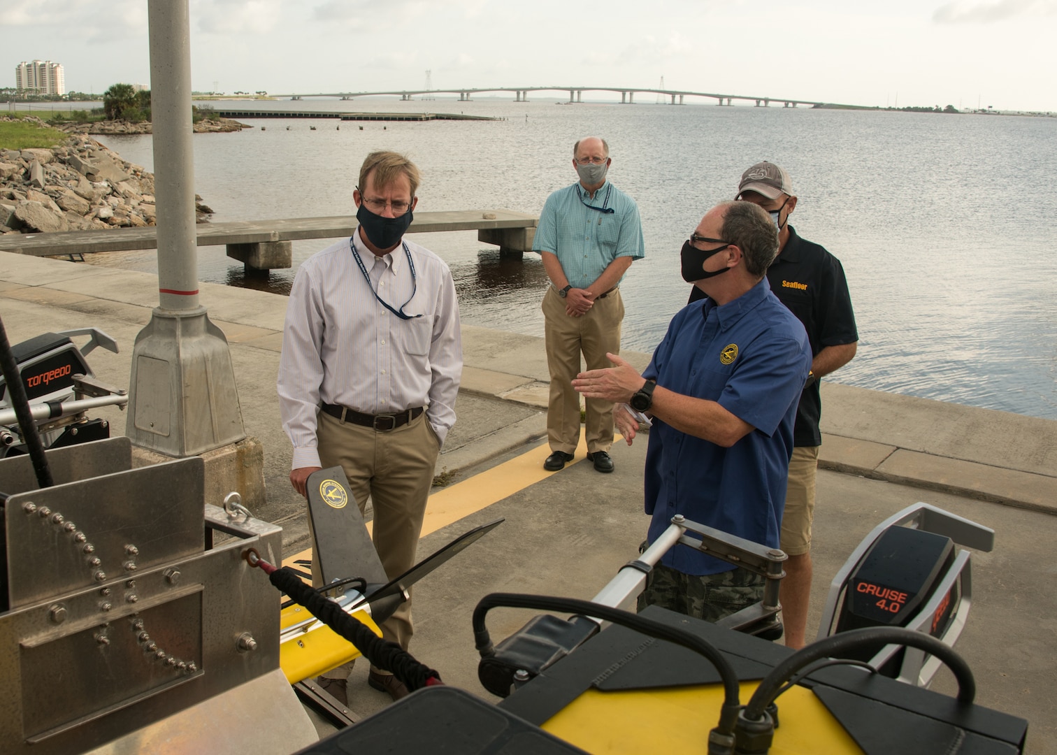 Naval Surface Warfare Center Panama City Division (NSWC PCD) recently collaborated with Commander, Naval Meteorology and Oceanography Command in coordination with the Naval Oceanographic Office’s Fleet Survey Team, and Klein Marine to conduct a live Advanced Naval Technology Exercise (ANTX) event at NSWC PCD. Richard Dentzman, right, from Klein Marine Systems describes the ANTX demonstration to Dr. Peter Adair, left, NSWC PCD technical director, as Dr. Todd Holland, NSWC PCD director, mine warfare prototyping, and John Tamplin from Seafloor Systems observe.