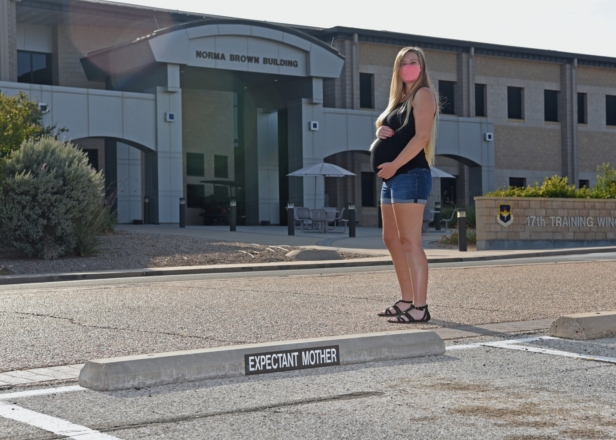 Goodfellow member, Sydney Sherwood displays her 28-week baby bump next to the 17th Training Wing’s newly implemented Expectant Mother’s front row parking outside of the Norma Brown building, on Goodfellow Air Force Base, Texas, Sept. 3, 2020.  Maternity parking spaces are not required by law; they were created to provide more diversity and inclusion resources around the base. (U.S. Air Force photo by Senior Airman Abbey Rieves)