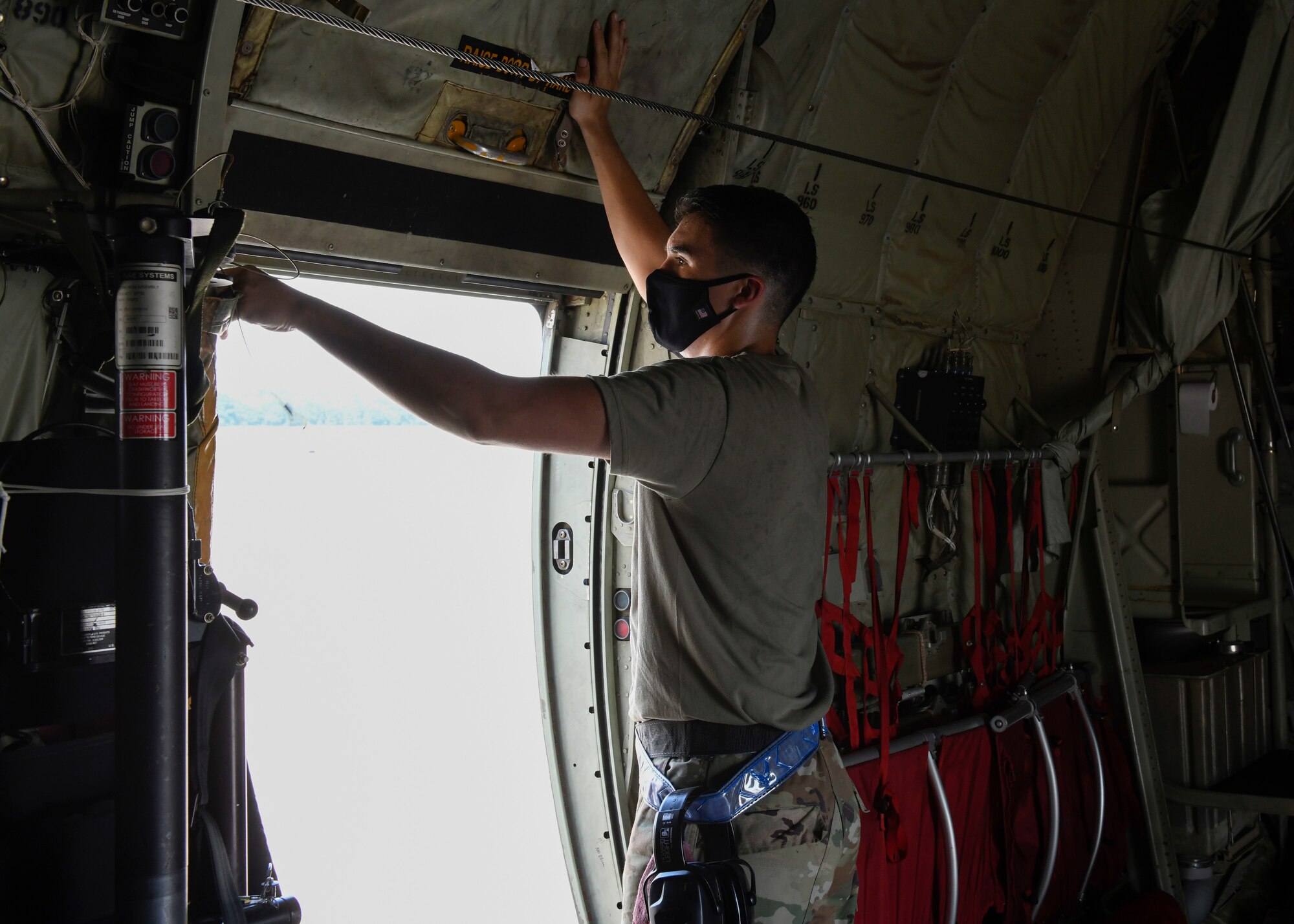 U.S. Air Force Reserve Airman 1st Class Micco Moore, 913th Aircraft Maintenance Squadron crew chief, opens the door of a C-130J Super Hercules at Little Rock Air Force Base, Ark., Sept. 10, 2020.  Moore used his passion and determination to fuel himself through training and stand out amongst his fellow Airmen along the way. (U.S. Air Force Reserve photo by Airman 1st Class Julia Ford)