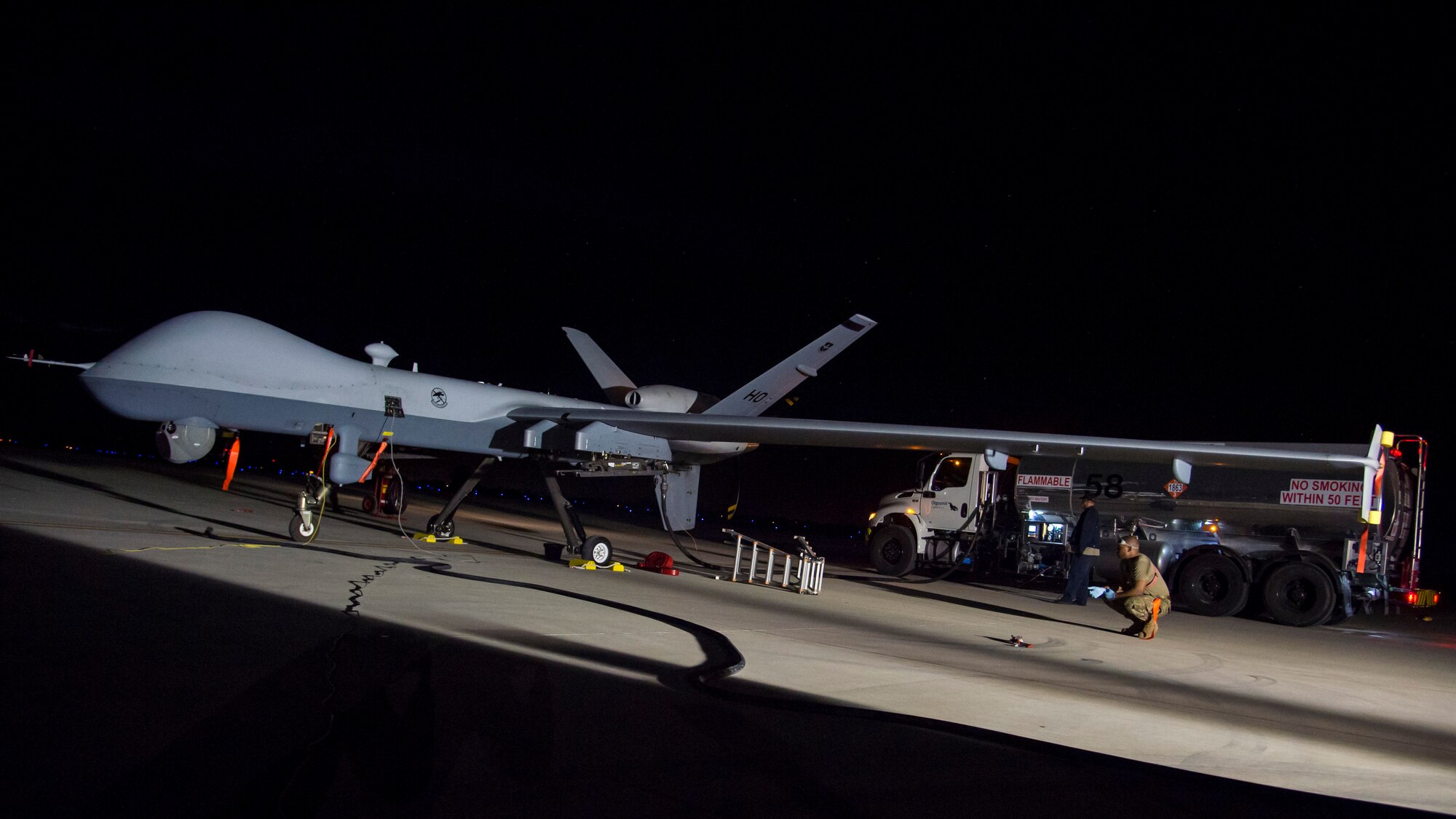 Tech. Sgt. Marquise Barfield, 49th Maintenance Group quality assurance inspector, observes a MQ-9 Reaper refueling during Exercise Agile Reaper Sept. 17, 2020, at Naval Air Station Point Mugu, California. This routine training exercise focuses on the superior training of next-generation warfighters while demonstrating the MQ-9’s ability to support forces during combat maritime training by rapidly moving persistent, multi-role aircraft across the battlespace when least expected. (U.S. Air Force photo by Senior Airman Collette Brooks)