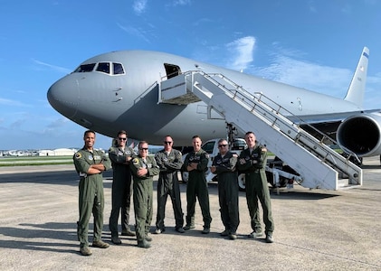 From left, Capt. Erik Earle, Capt. Chris Schimmel, Maj. Matt Valentino, Master Sgt. Brett Peterson, Capt. Jordan Gauvin, Chief Master Sgt. Michael George and Maj. Leon Rice stand with a KC-46A Pegasus on Sept. 8, 2020, at Kadena Air Base, Japan.