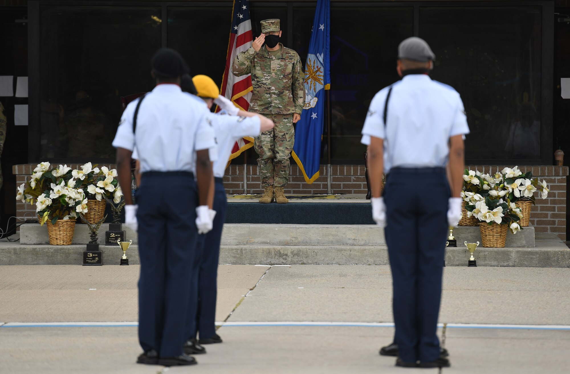 U.S. Air Force Col. Chance Geray, 81st Training Group commander, returns a salute to members of the 335th Training Squadron regulation drill team during the 81st TRG drill down on the Levitow Training Support Facility drill pad at Keesler Air Force Base, Mississippi, Sept. 18, 2020. Airmen from the 81st TRG competed in a quarterly open ranks inspection, regulation drill routine and freestyle drill routine. Keesler trains more than 30,000 students each year. While in training, Airmen are given the opportunity to volunteer to learn and execute drill down routines. (U.S. Air Force photo by Kemberly Groue)