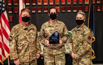 Alaska Air National Guardsmen Lt. Col. Shane Wallace and Chief Master Sgt. Heather Pineiro, the Commander and Chief Enlisted Manager assigned to the 176th Air Defense Squadron stand beside 1st Sgt. Melissa Erhard, the Alaska Air National Guard's 2019 First Sergeant of the Year, Sept. 15, 2020 on Joint Base Elmendorf-Richardson. Erhard distinguished herself in 2019 through her ability to foster resiliency among her Airmen and her community. The red stars in the backdrop represent the number of Russian intercepts made by the unit through the years, whose mission is to defend the nation's Air Sovereignty in the region. (U.S. Army National Guard photo by Sgt. Seth LaCount/Released)