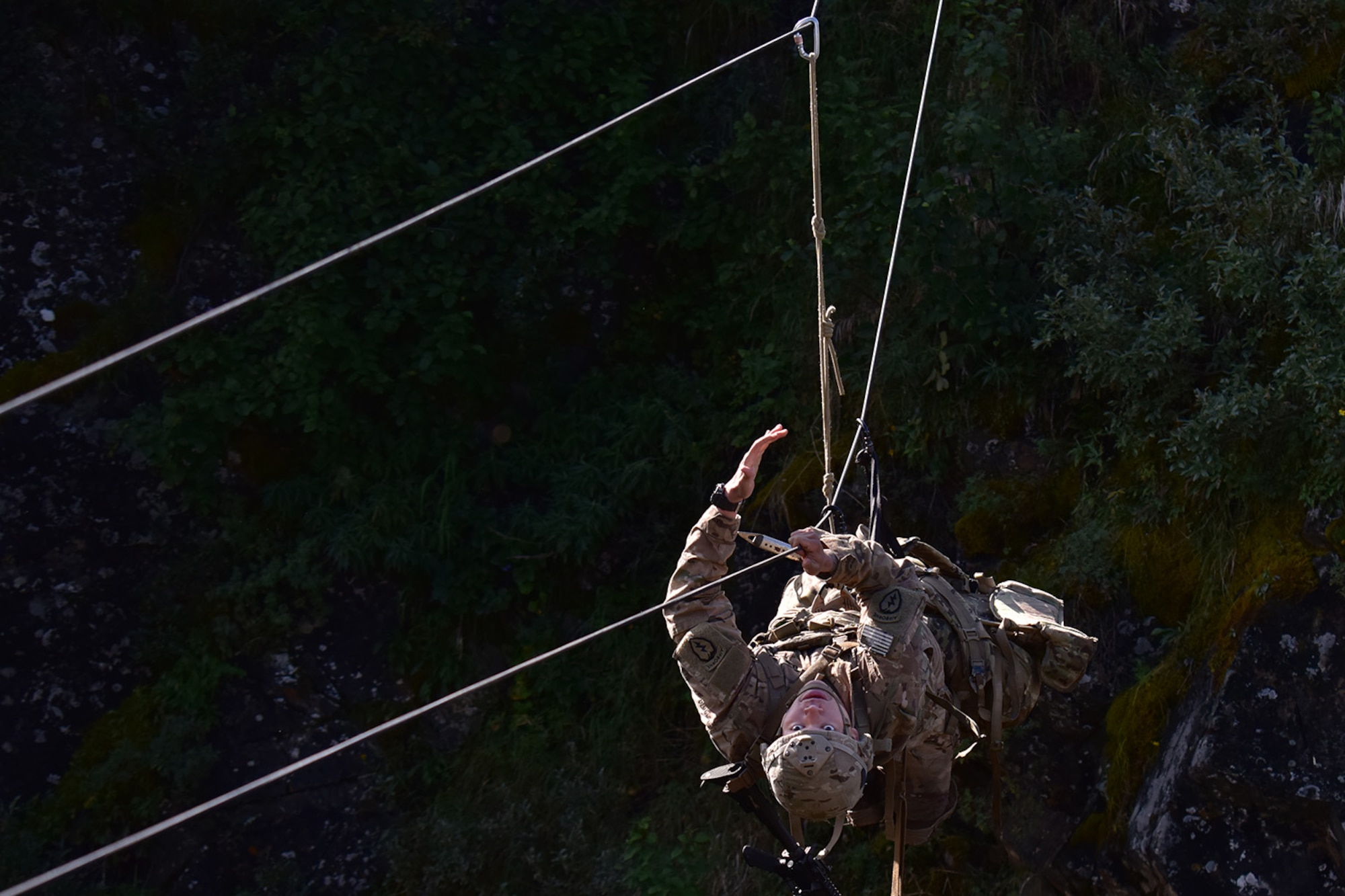 Basic Military Mountaineering Course student Spc. Kevin Vang crosses a rope bridge over a mountain gorge at the Northern Warfare Training Center’s Black Rapids Site during training. NWTC cadre followed Coronavirus restrictions while guiding students through both the basic and advanced mountaineering courses in August. With the advent of Alaska’s long, cold winter, NWTC’s focus is now shifting to cold weather training for the 2020-21 season.