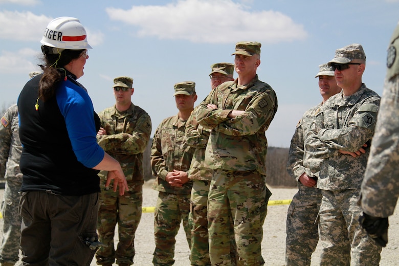 U.S. Army Engineer Research and Development Center, Construction Engineer Research Laboratory mechanical engineer and Additive Construction technical team leader, Megan Kreiger, briefs Army officers during the Maneuver Support, Sustainment, Protection and Integration Experiment printing technology demonstration, at Fort Leonard Wood, Mo., April 2018.