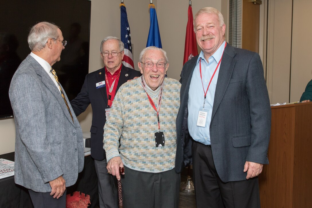 Bud Ossey (center) reconnects with fellow retirees of Portland District, U.S. Army Corps of Engineers during a historical celebration at the district’s headquarters in downtown Portland in November 2019. Ossey attended as a guest of honor.