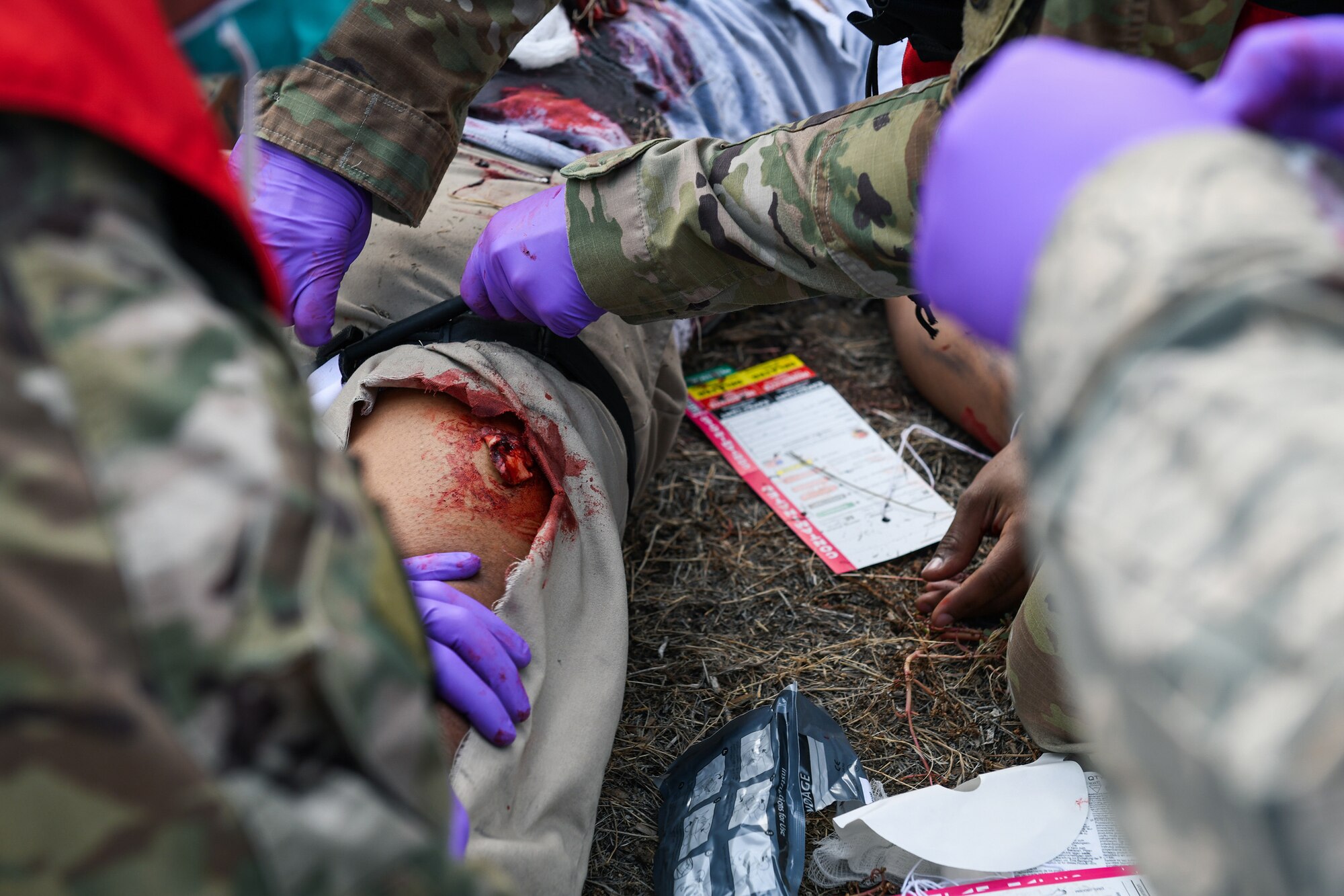 Airmen from the 460th Medical Group apply a tourniquet to a wounded patient during the Ready Eagle exercise where a simulated explosion occurred Sept. 18, 2020, at the Air Reserve Personnel Center on Buckley Air Force Base, Colo.