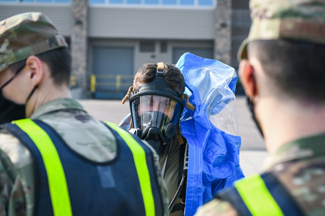 Senior Airman Justin Kunkler, a 460th Operational Medical Readiness Squadron journeyman, dons his full hazardous materials (hazmat) suit during the Ready Eagle exercise where a simulated explosion occurred Sept. 18, 2020, at the Air Reserve Personnel Center on Buckley Air Force Base, Colo.