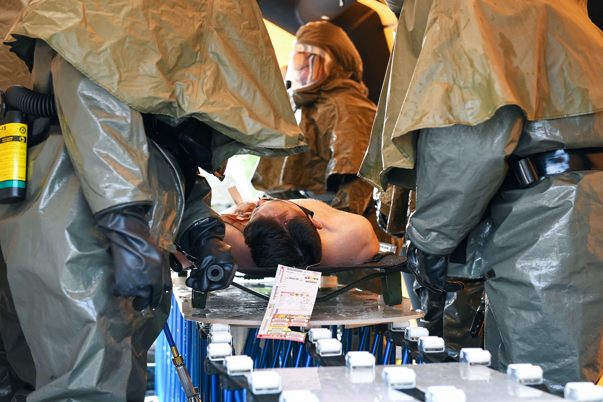 Airmen from the 460th Medical Group wash a victim in a decontamination tent during the Ready Eagle exercise Sept. 18, 2020, at the North Medical Building on Buckley Air Force Base, Colo.