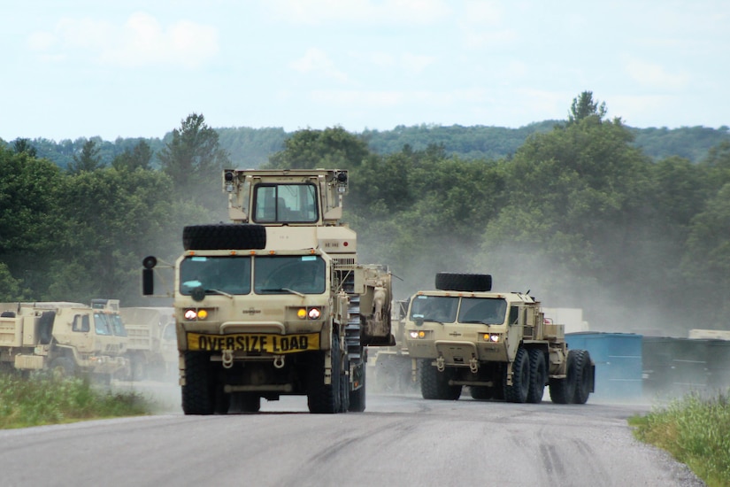 Military vehicles moving in a convoy.