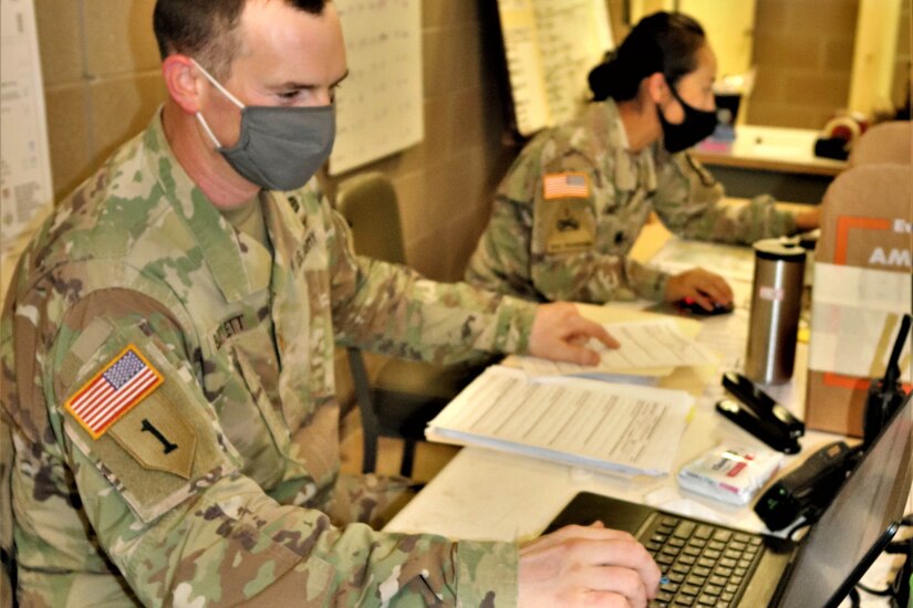 Soldiers wearing face masks working.