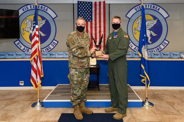 U.S. Air Force Col. Corey Simmons, 60th Air Mobility Wing Commander, left, presents Senior Master Sgt. Marcus Hewett, 6th Air Refueling Squadron superintendent, the Staff Sgt. Henry E. “Red” Erwin Outstanding Career Enlisted Aviator of the Year Award Sept. 18, 2020, at Travis Air Force Base, California. The award recognizes airmen with outstanding accomplishments in the aircrew operations career fields with significant results, major mission impact, demonstration of outstanding leadership and professional qualities, and superior contributions to the roles and missions of the USAF. (U.S. Air Force photo by Chustine Minoda)