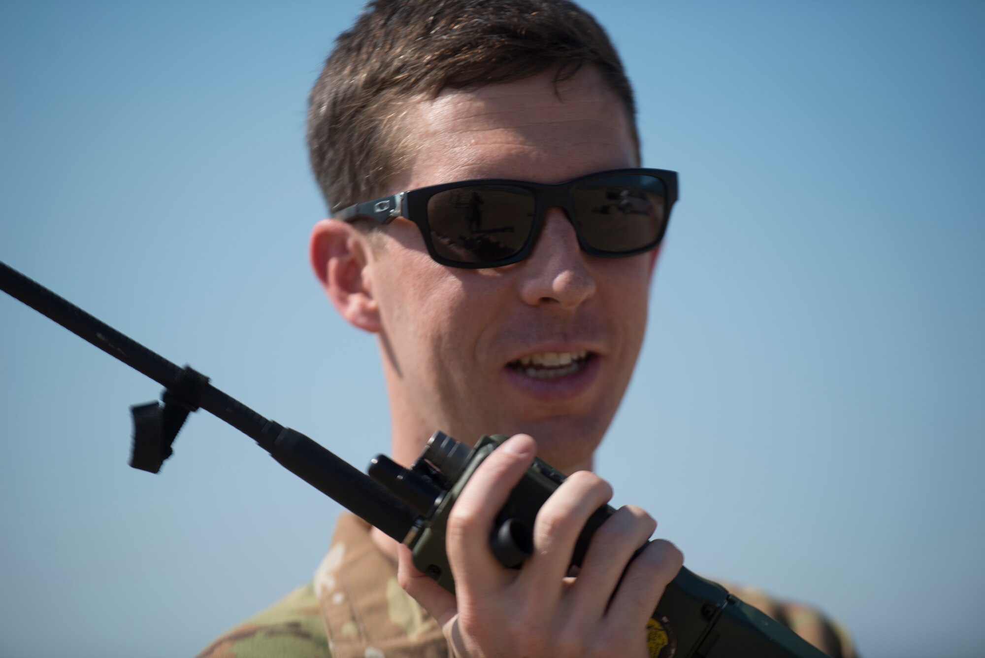 An Airman relays information on a radio.