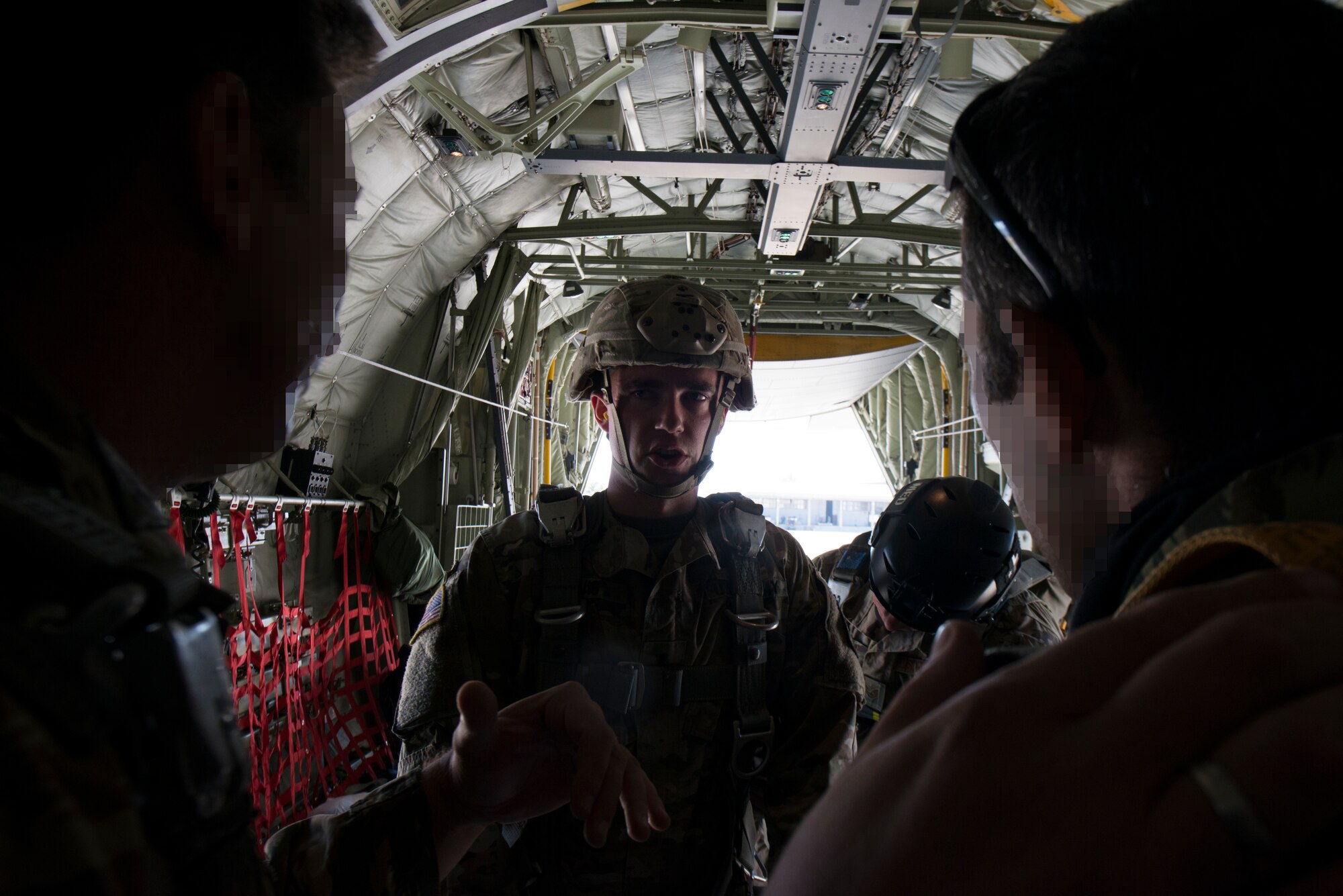 An Army paratrooper speaks with Hellenic forces members.