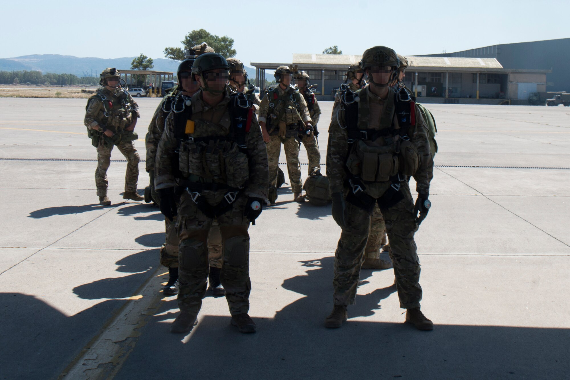 Hellenic forces members stand in a line.