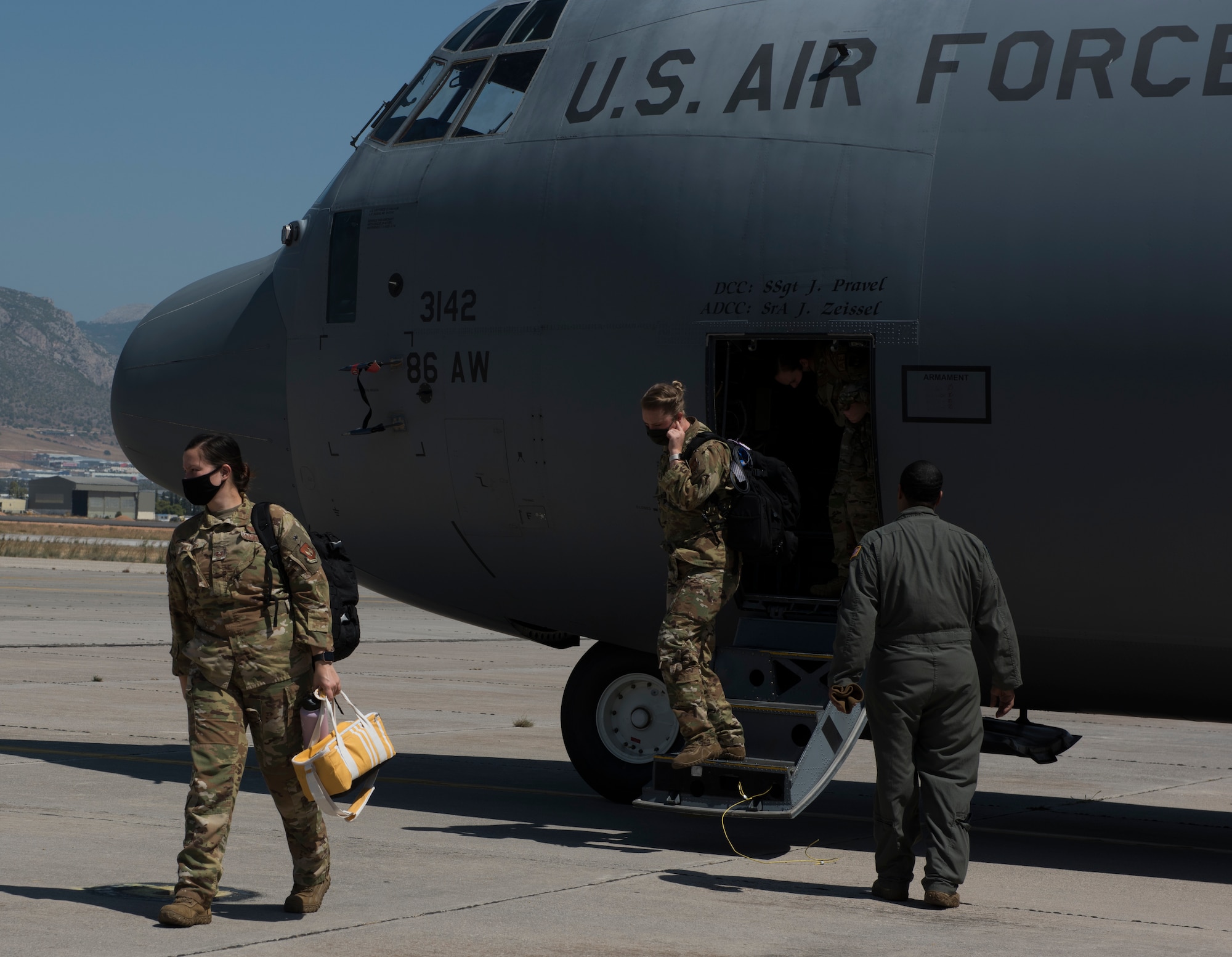 Airmen depart a C-130J aircraft.