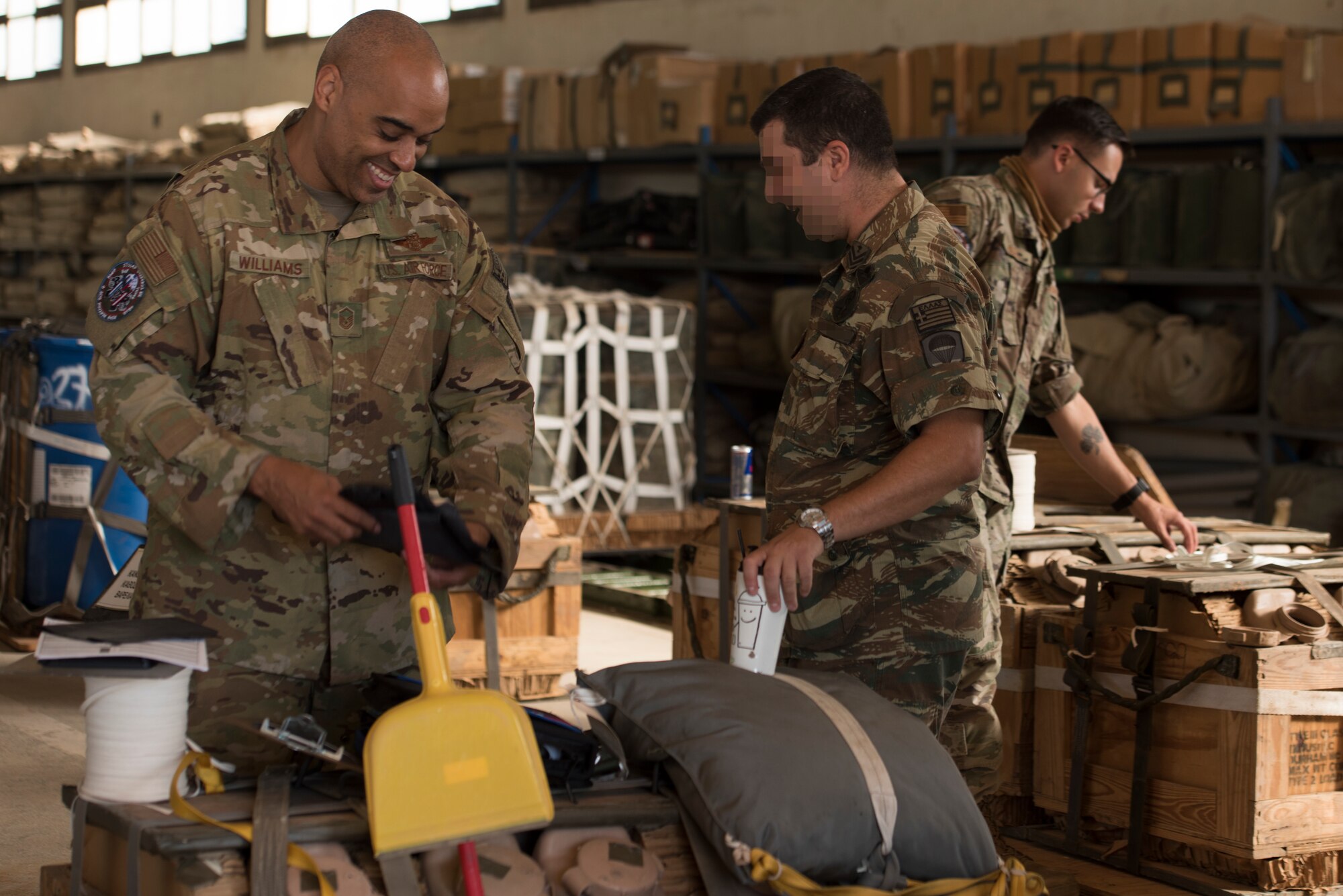 An Airman speaks with a Hellenic paratrooper.