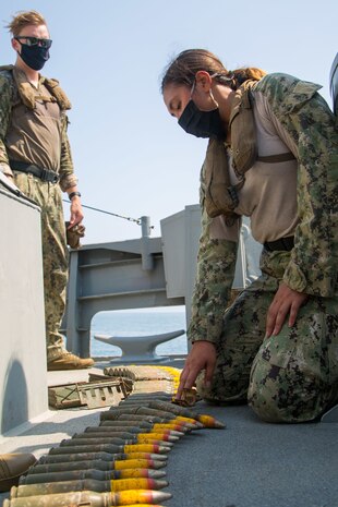 Gunner’s Mate 2nd Class Kelsey O’Keefe, assigned to Commander, Task Force (CTF) 56, prepares ammunition for a Mark 38 Mod 2 25mm gun aboard a Mark VI patrol craft during live-fire training in the Arabian Gulf, Sept. 15. CTF 56 is responsible for planning and execution of expeditionary missions, in the U.S. 5th Fleet area of operations and is deployed in support of naval operations to ensure maritime stability and security in the Central Region, connecting the Mediterranean Sea and Pacific Ocean through the Western Indian Ocean and three strategic chokepoints to the free flow of global commerce. (U.S. Army photo by Spc. Joshua DuRant)