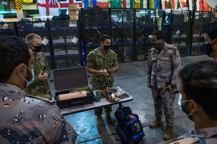 U.S. Coast Guard Maritime Law Enforcement Specialist 1st Class George Soto, middle, assigned to Coast Guard Patrol Forces Southwest Asia (PATFORSWA), shows medical equipment used for visit, board, search and seizure (VBSS) operations to members of the Saudi Arabian Border Guard and Combined Task Force (CTF) 152, during a visit to the Coast Guard Maritime Engagement Team training facility on board Naval Support Activity Bahrain, Sept. 10. PATFORSWA is comprised of the Maritime Engagement Team, shoreside support personnel and six 110' cutters and is the Coast Guard's largest unit outside of the U.S., playing a key role in supporting the Navy’s maritime security and maritime infrastructure protection operations in the U.S. 5th Fleet area of operations.